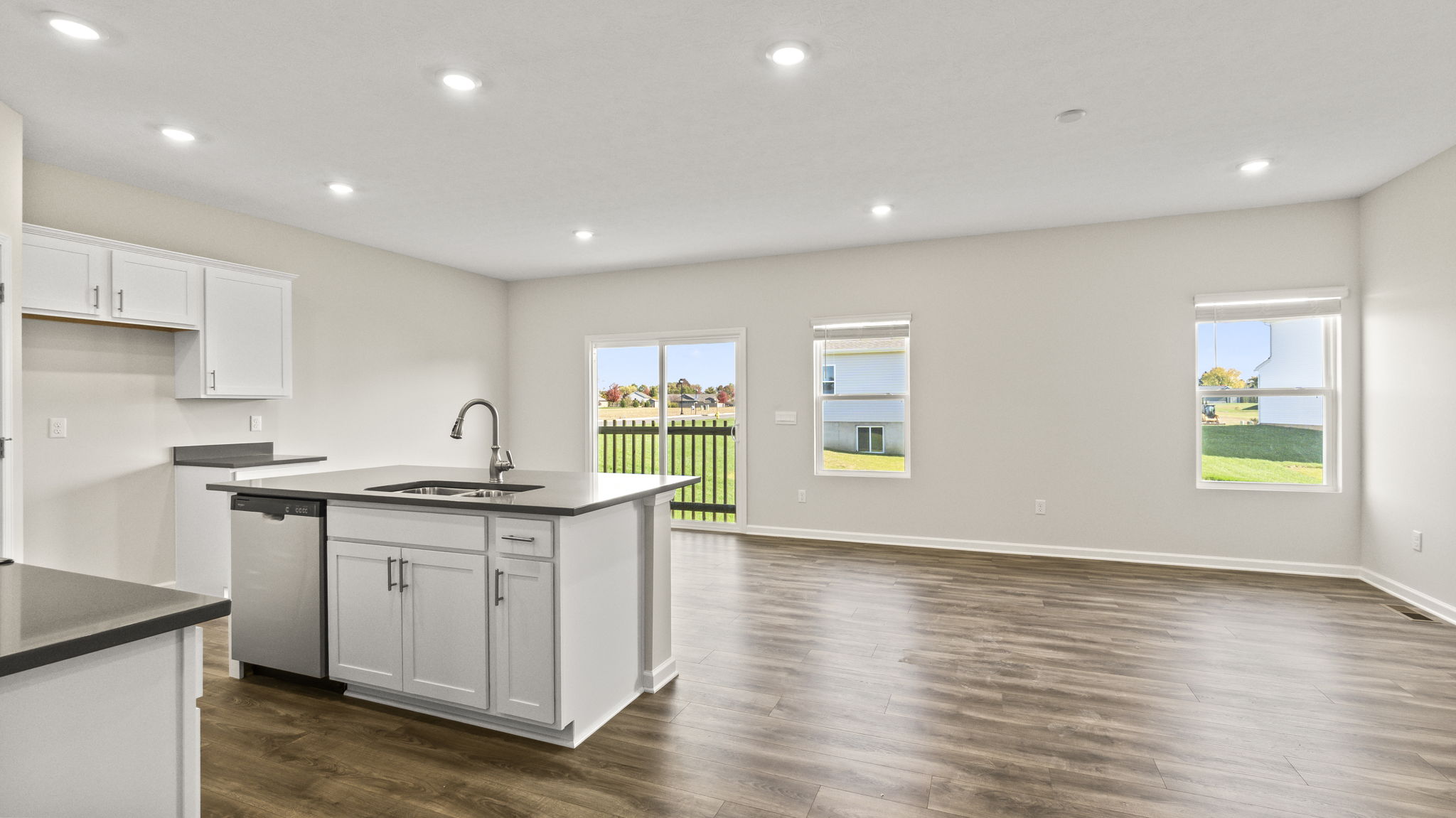 Living room and kitchen from the hallway with view of island.