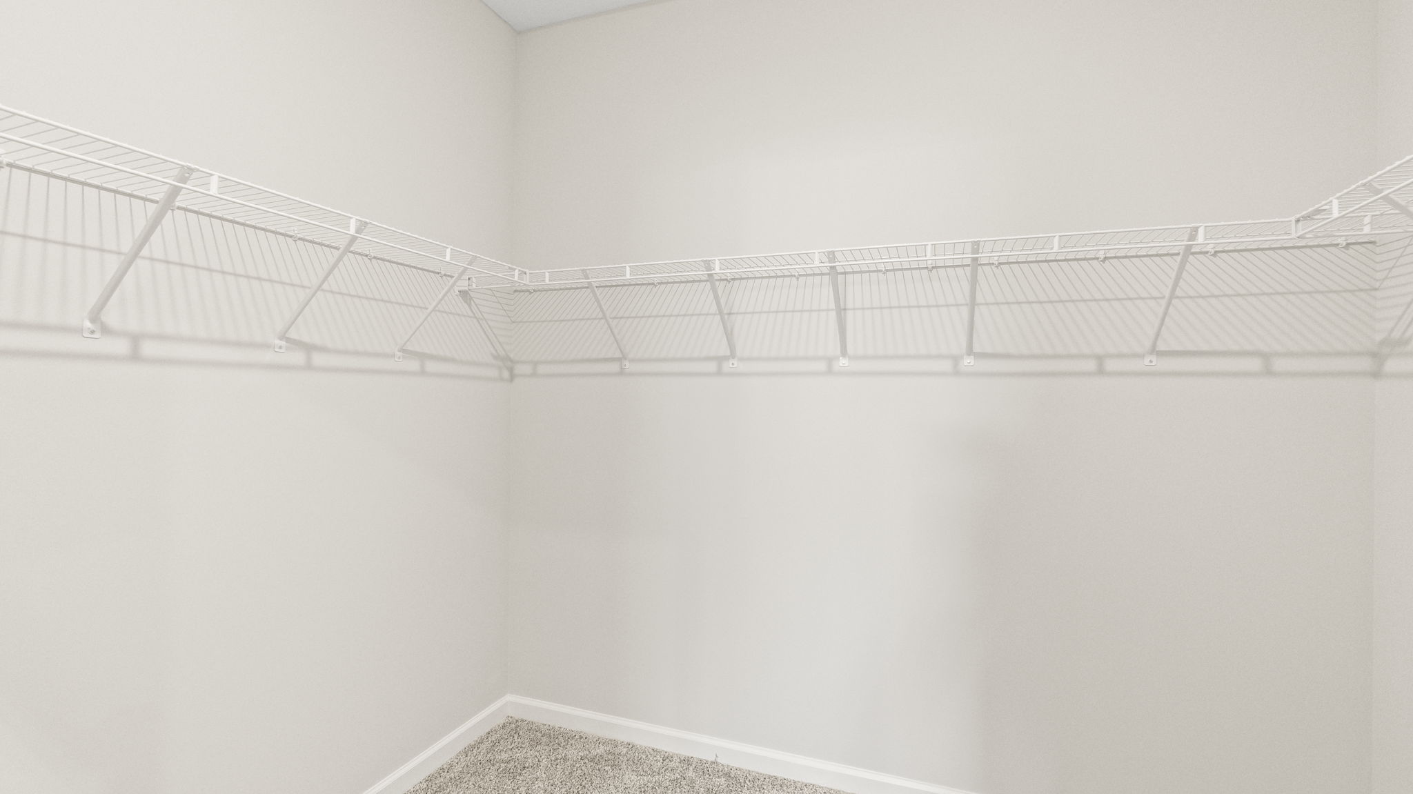 Walk-in closet with wire shelving.