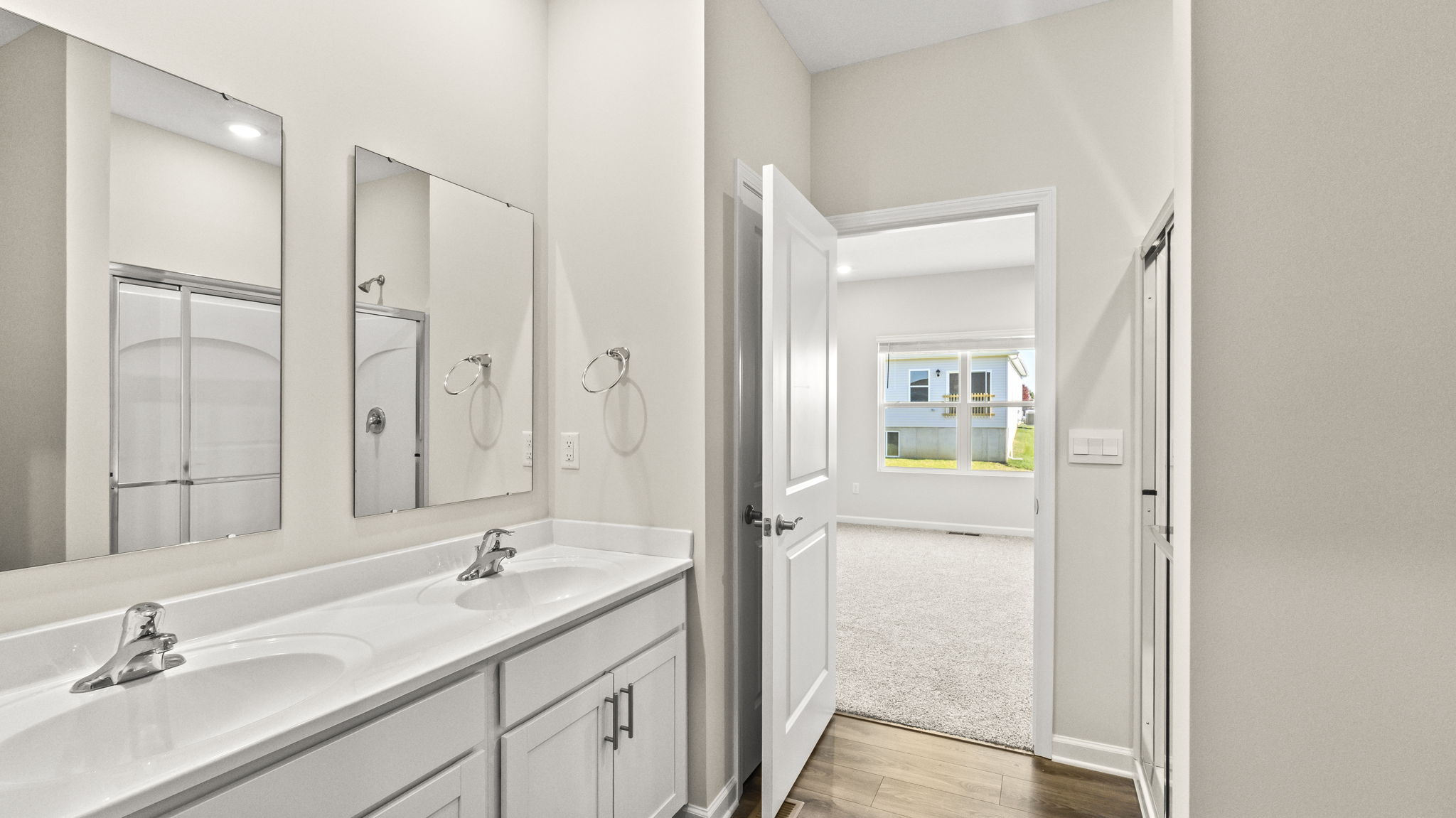Primary bathroom suite looking into primary bedroom.