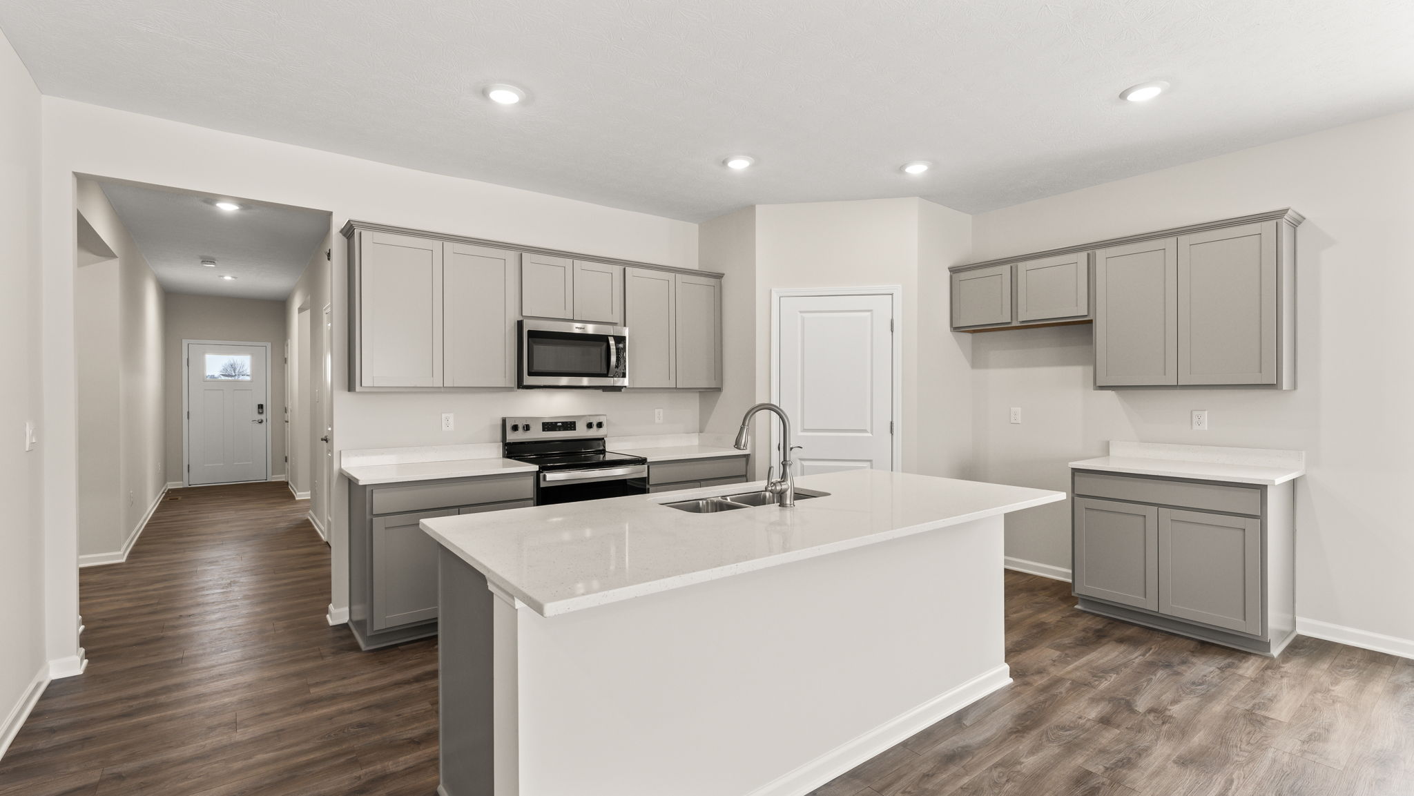 Full kitchen with island, cabinetry, and appliances
