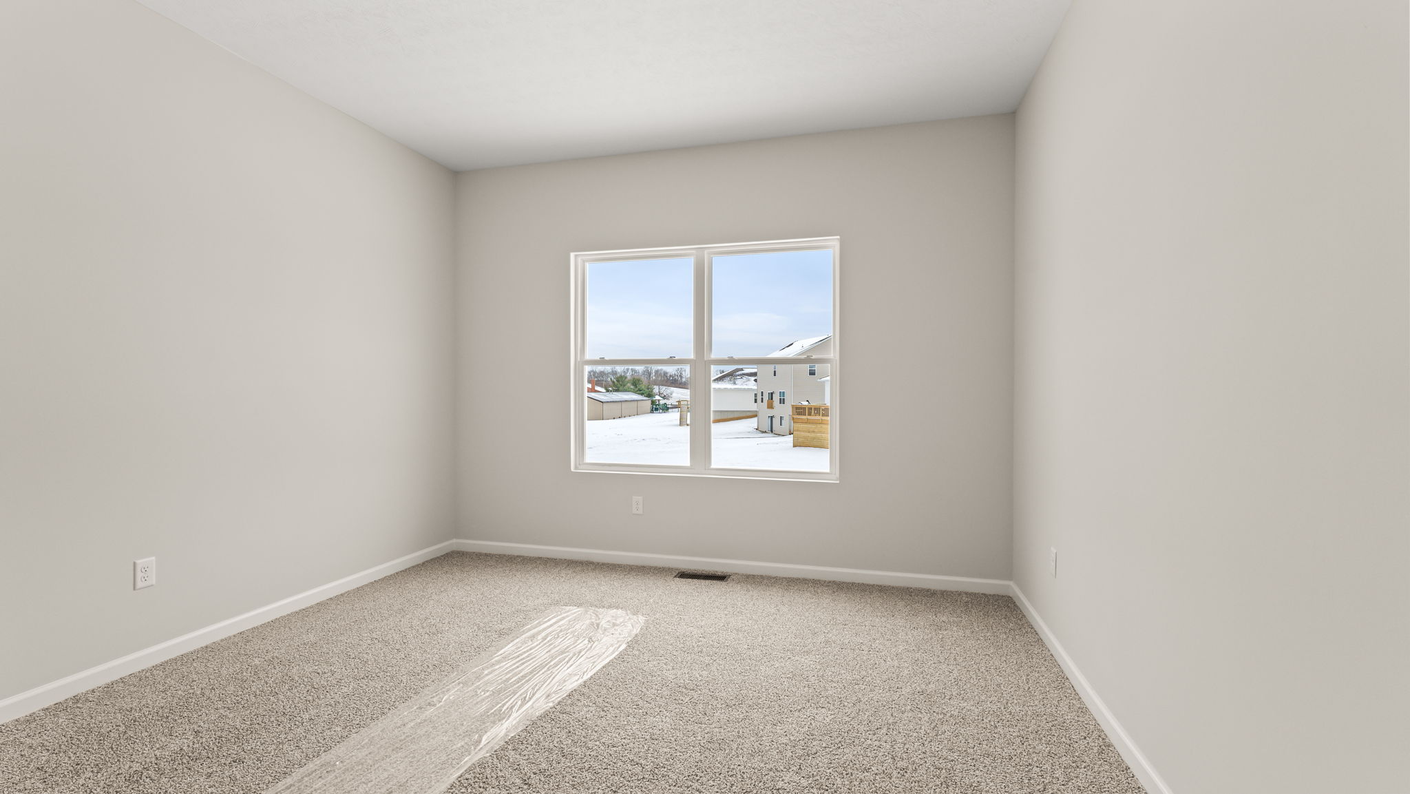 Primary bedroom with carpet and window