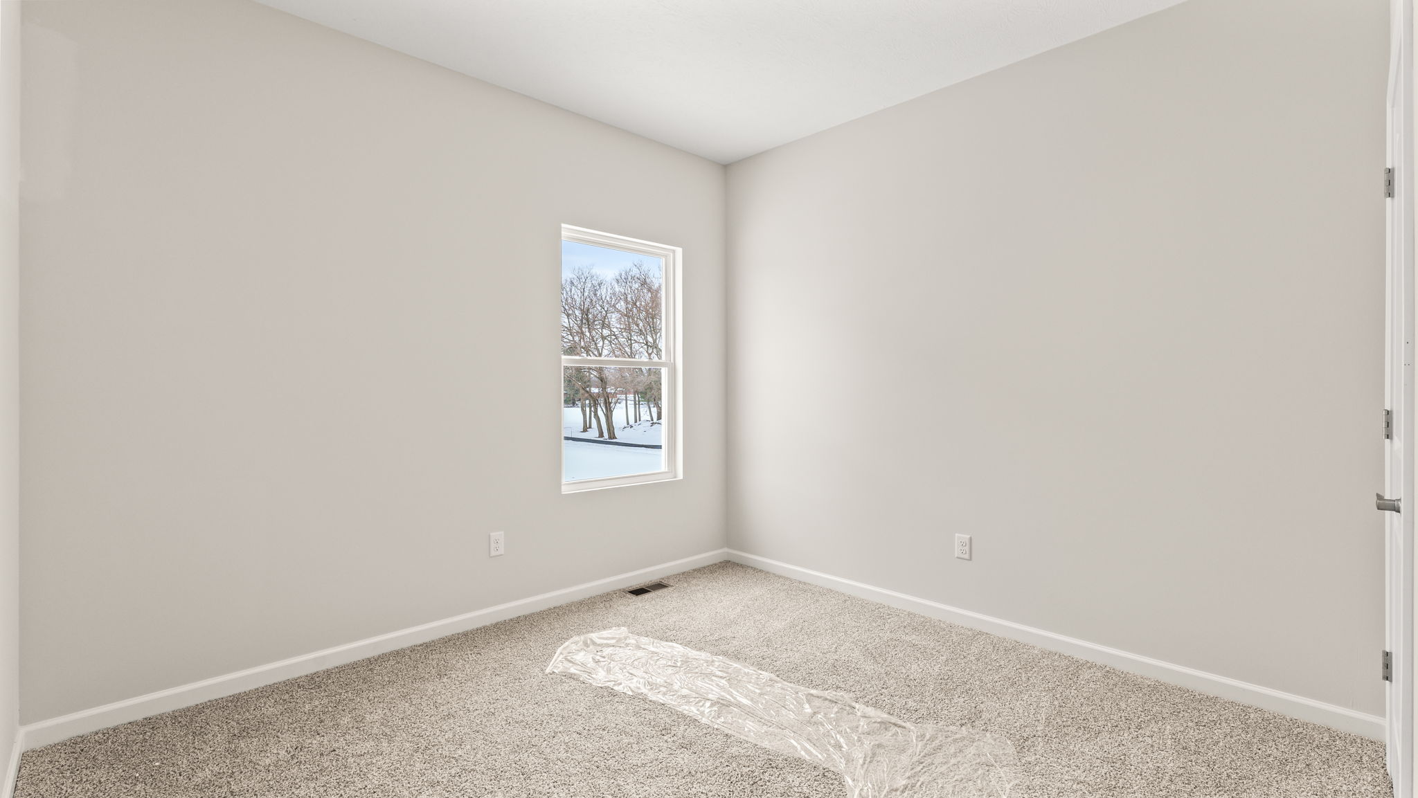 Bedroom with carpet, outlets, and windows,