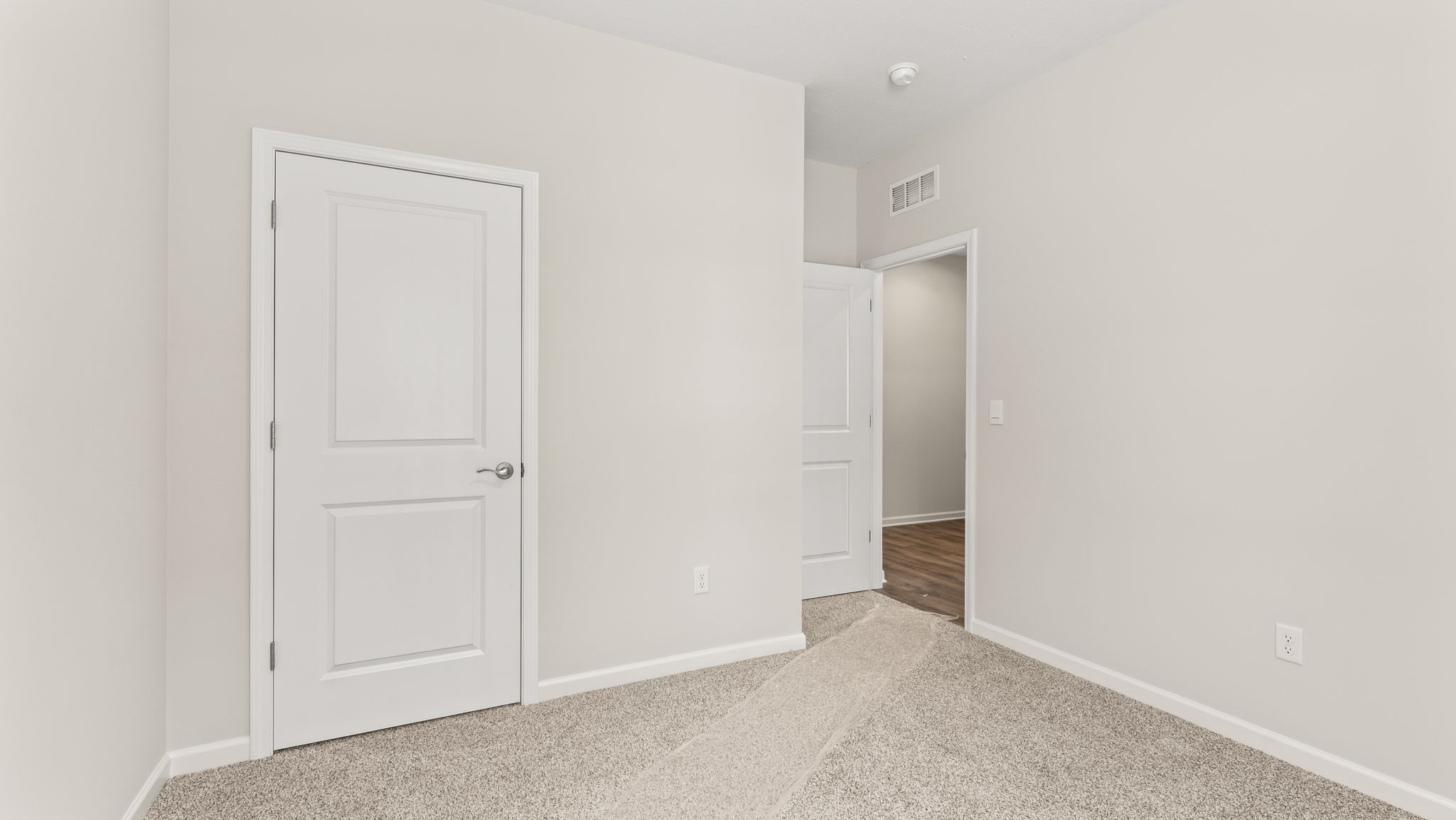 Bedroom with closet door and door to hallway