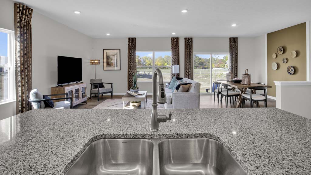 Corner view of kitchen with beautifully decorated open concept great room.
