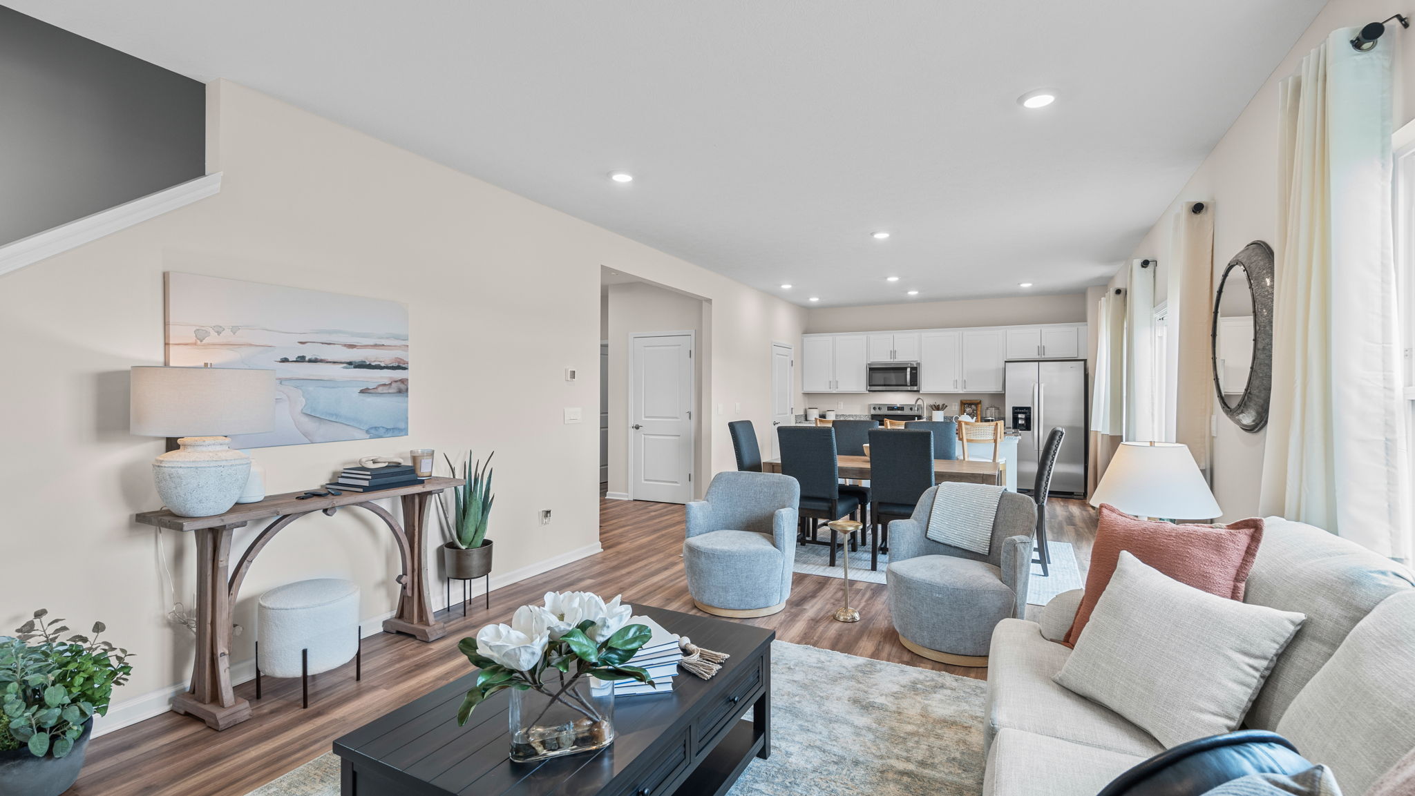 Open living room with view of kitchen and dining area.