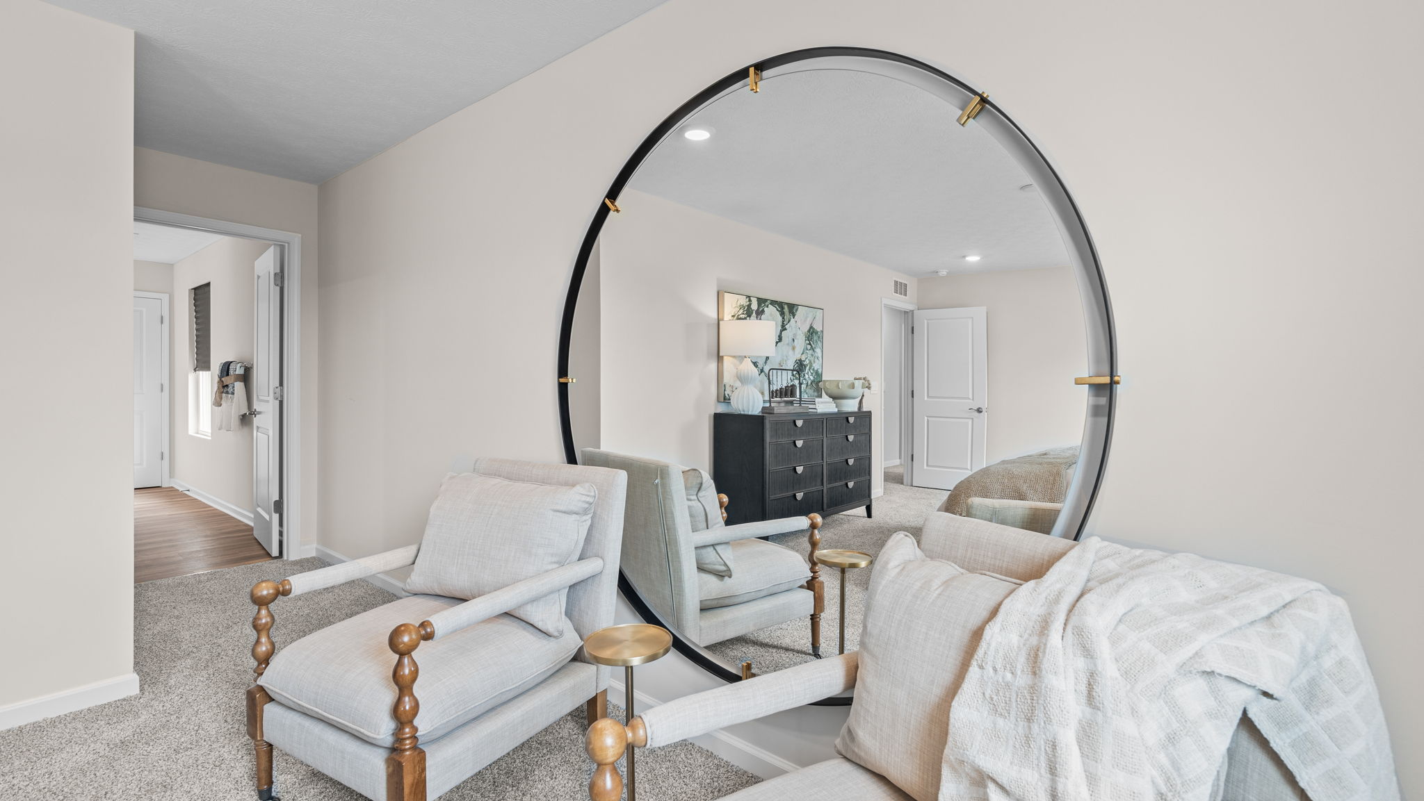 Primary bedroom with room for large mirror and seating area.