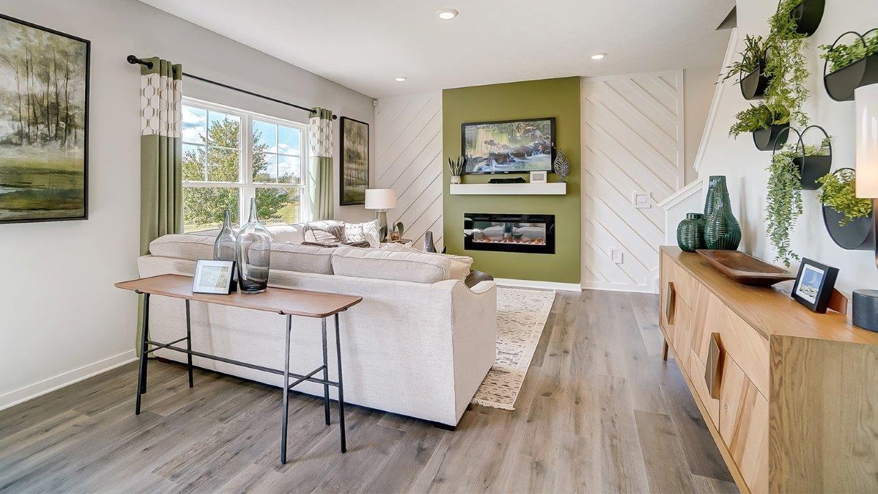 Living room with green accents and modern décor.