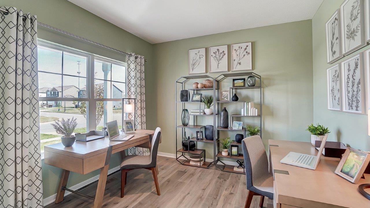 Office with 2 desks and modern art.