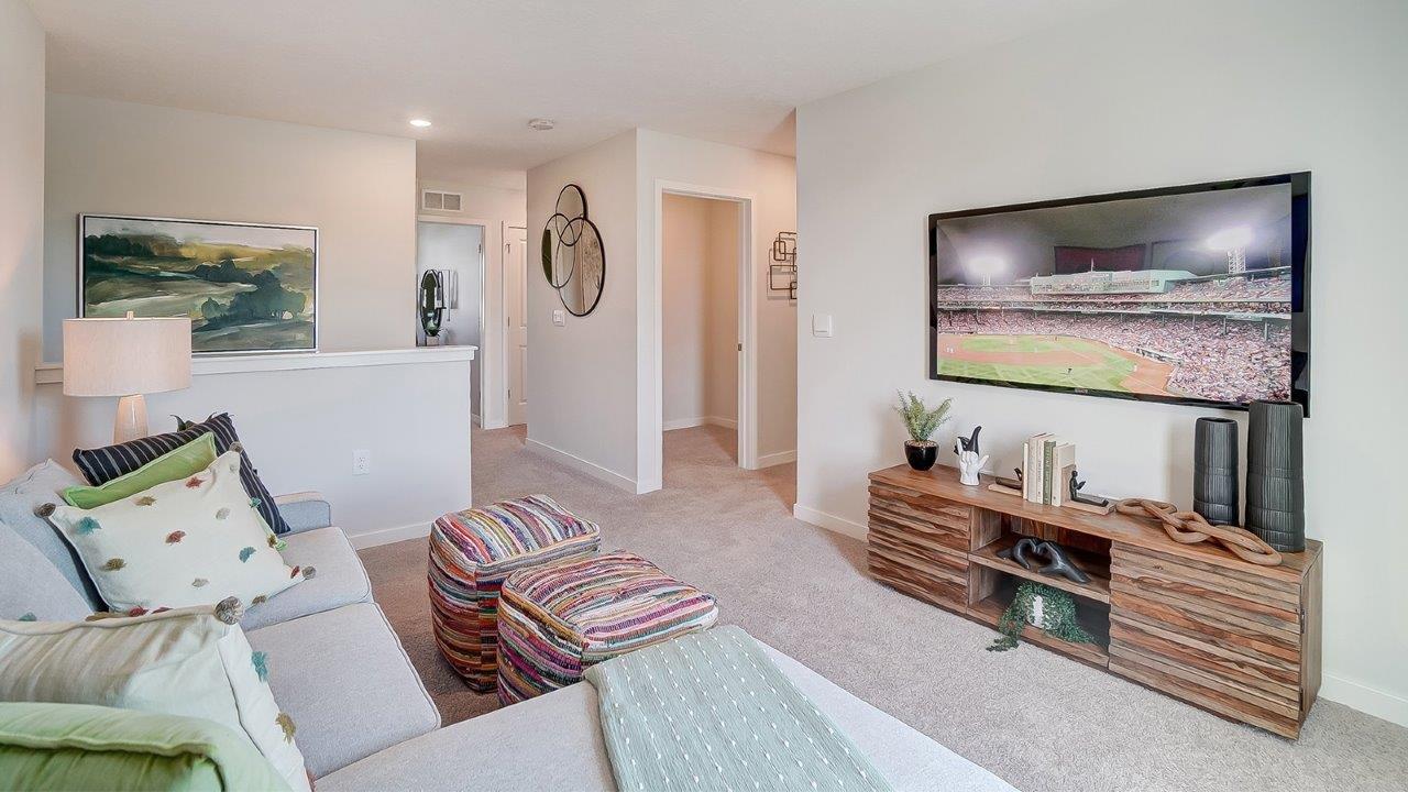 Upstairs loft with tv and art.