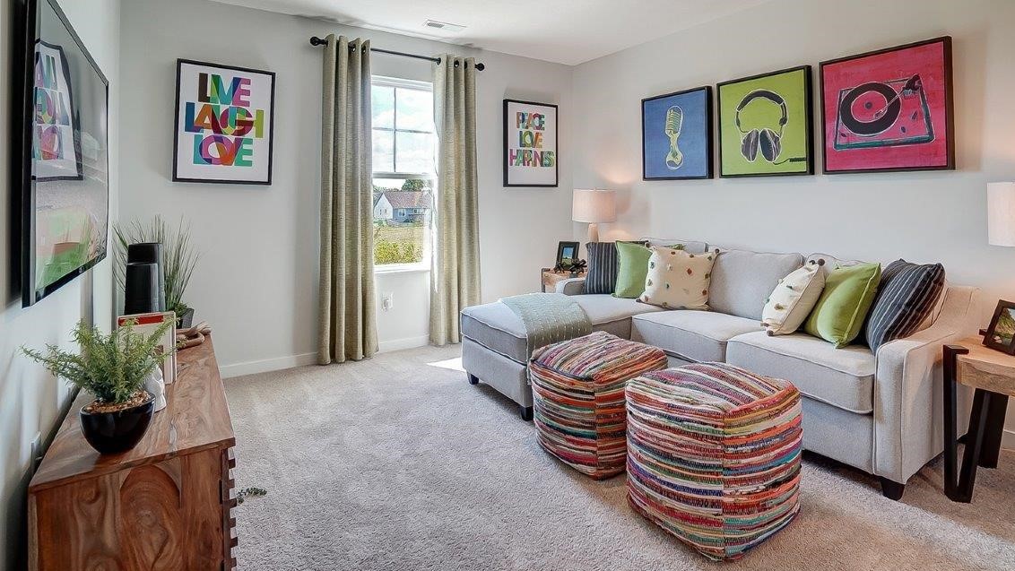 Upstairs loft with comfy couch and wooden couch stands.