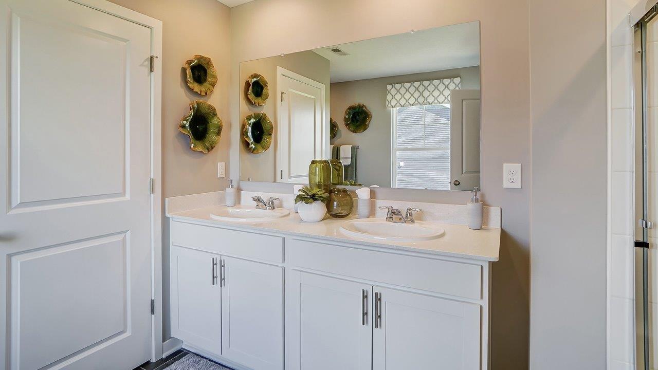 primary bathroom with dual vanity sinks.