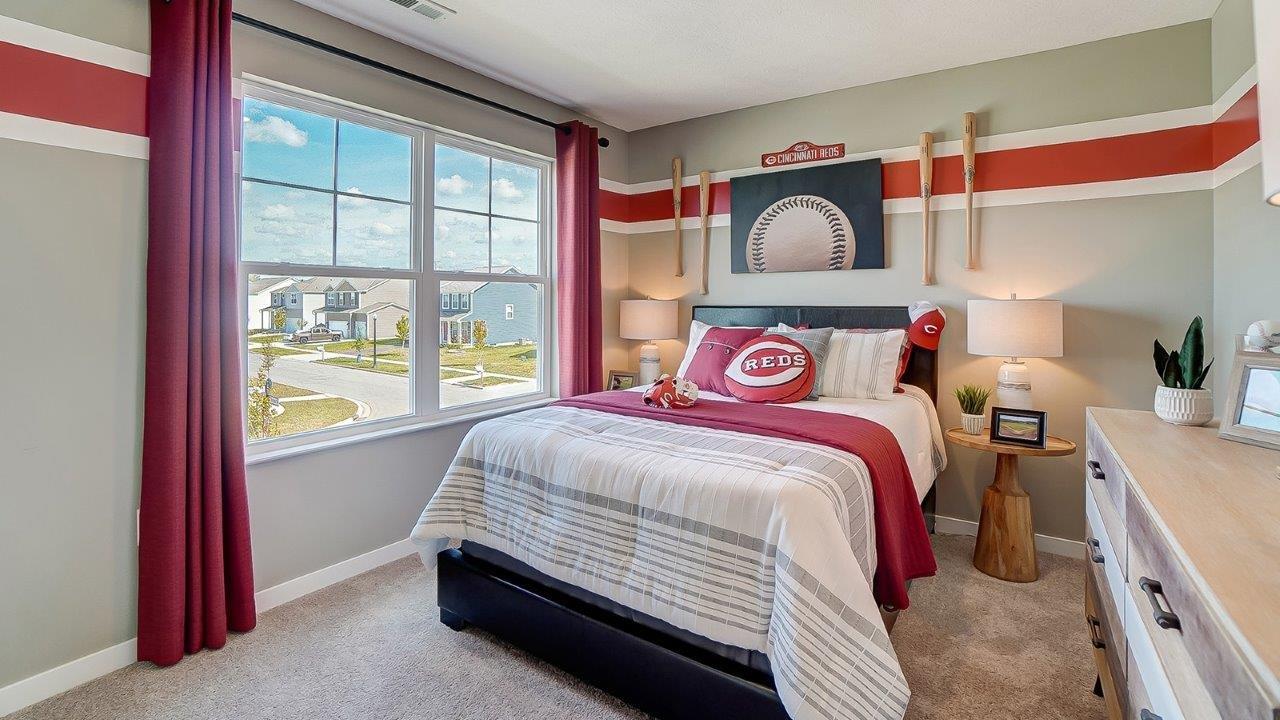 Bedroom 2 with Reds theme throughout and large windows.
