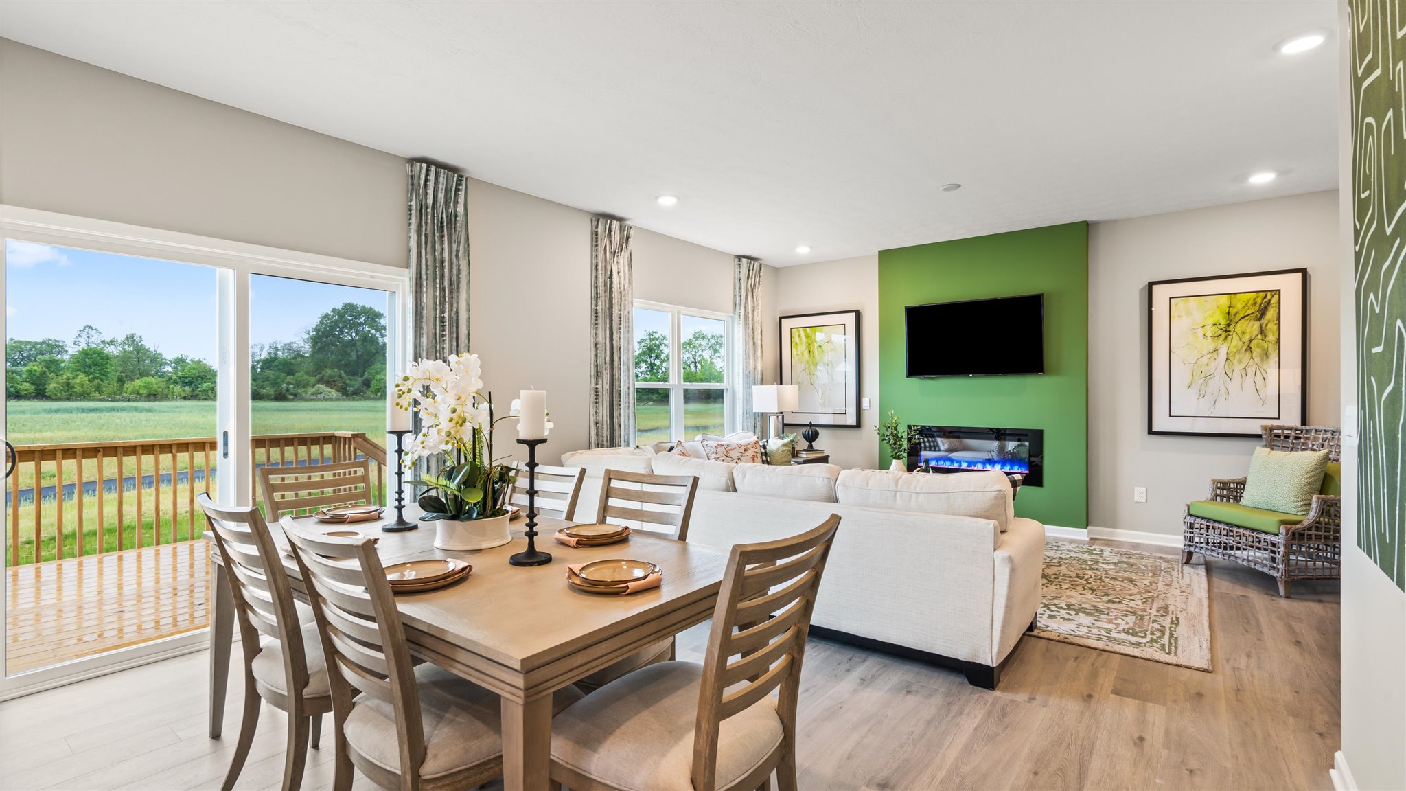 view of both casual dining area and living room with green accents and modern art.
