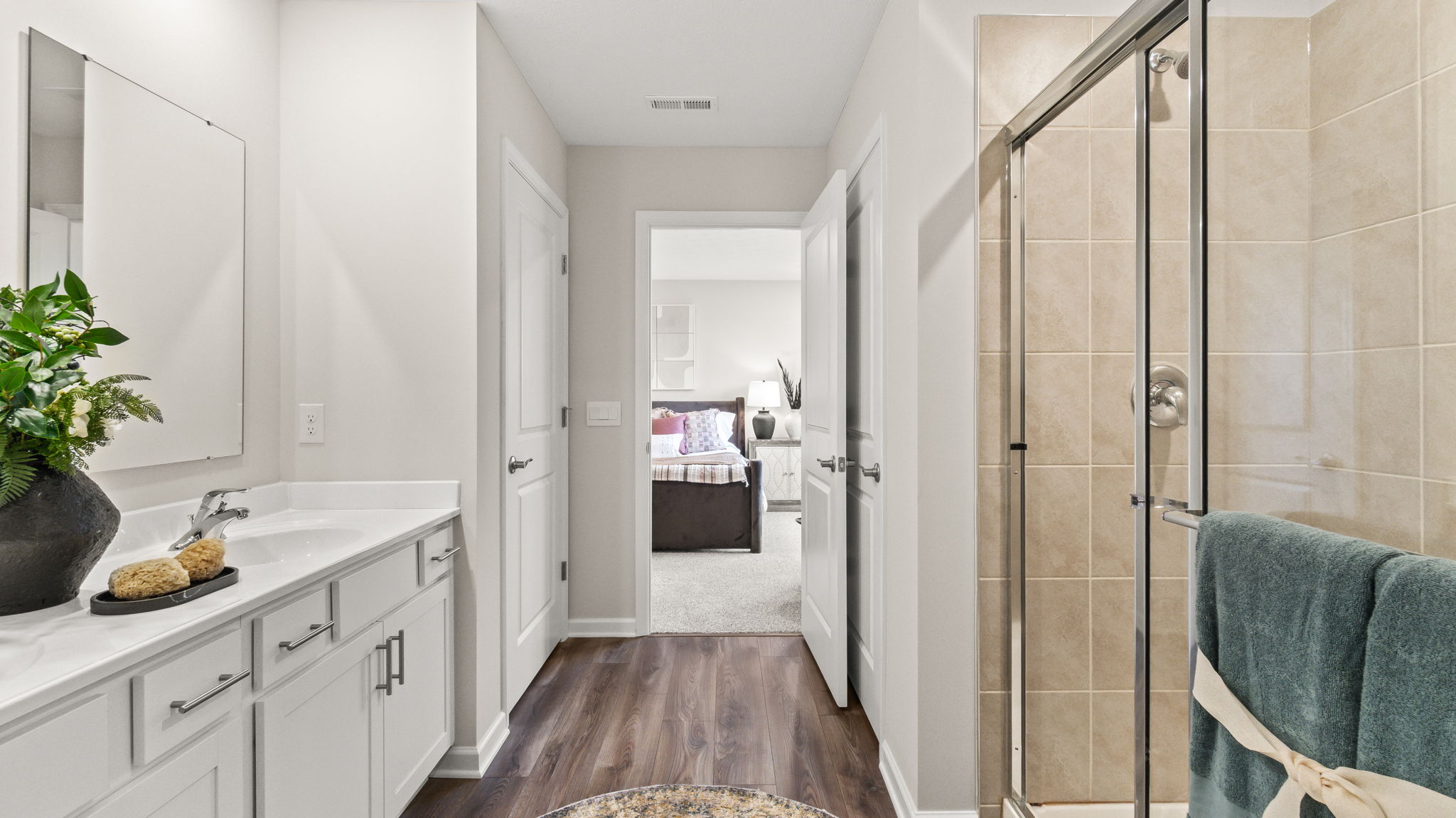 Primary bathroom looking into primary bedroom.