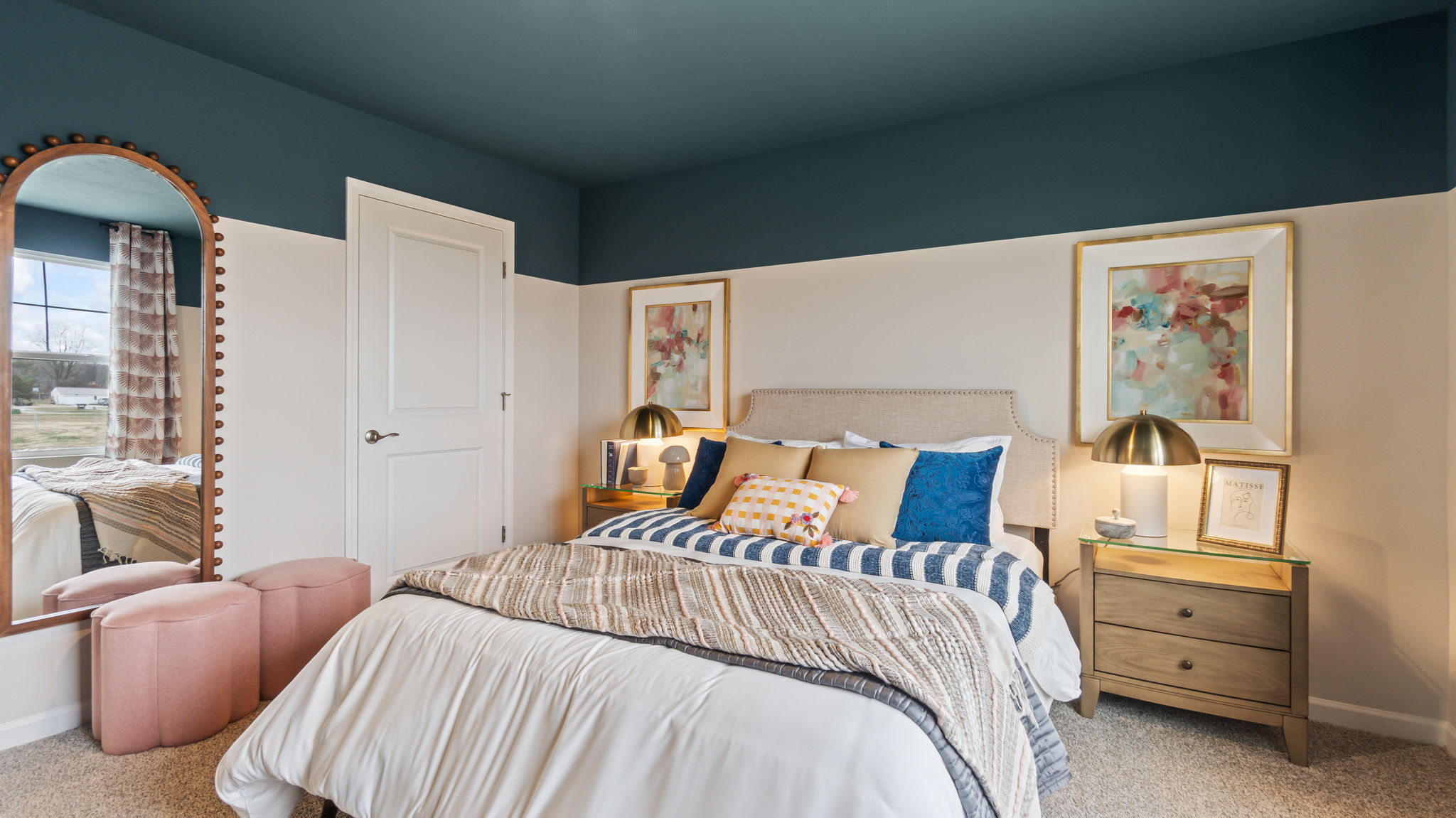 Reverse of bedroom 3 with Queen bed,  blue and pink pastel color decorations, art, and paint.