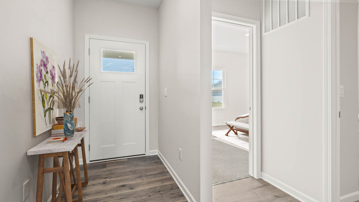 Foyer and front door with part of front bedroom.