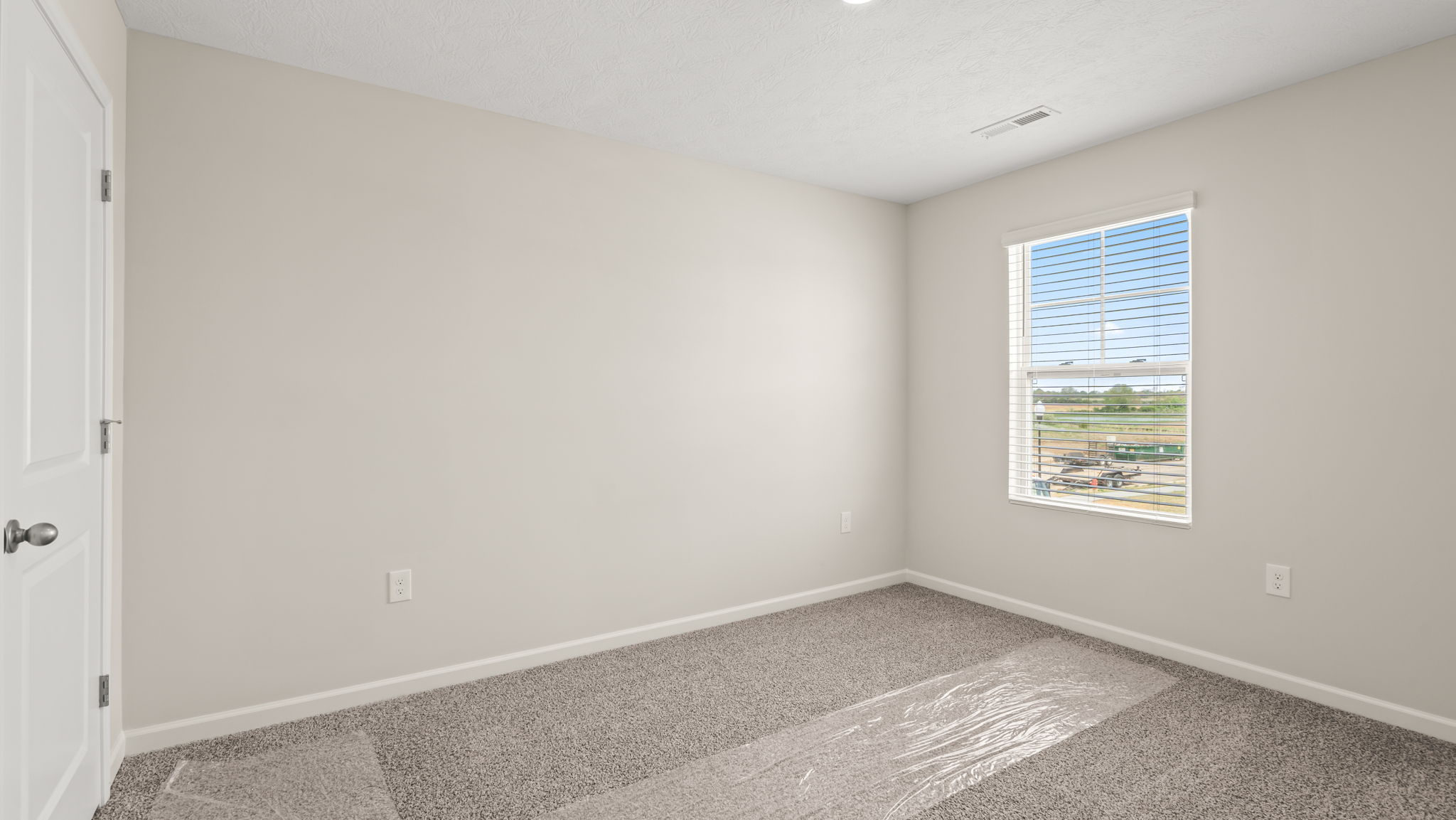 Carpeted bedroom with window
