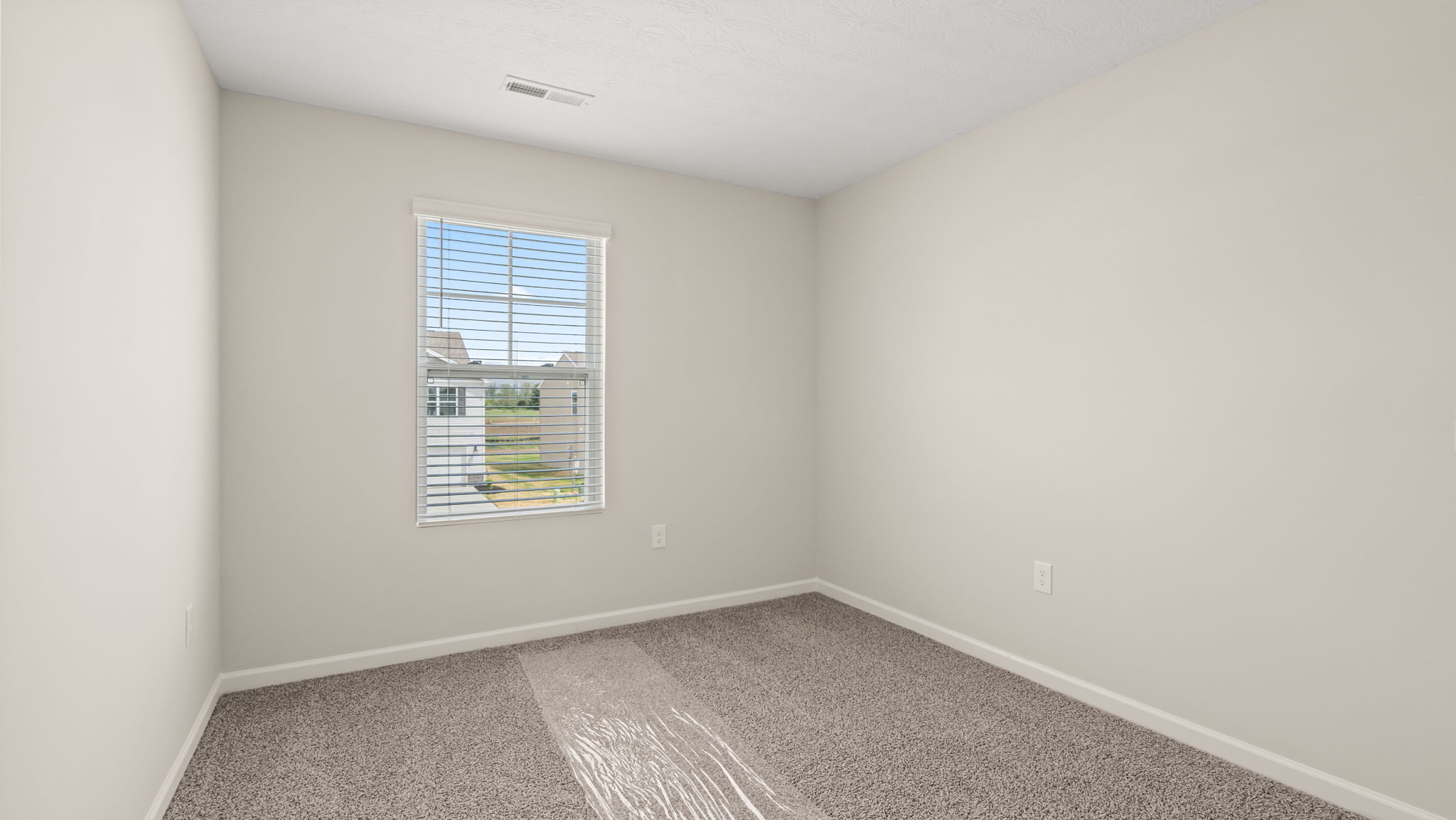 Carpeted bedroom with window