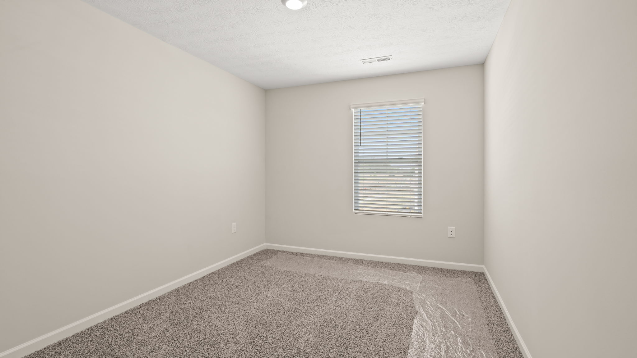 Carpeted bedroom with window
