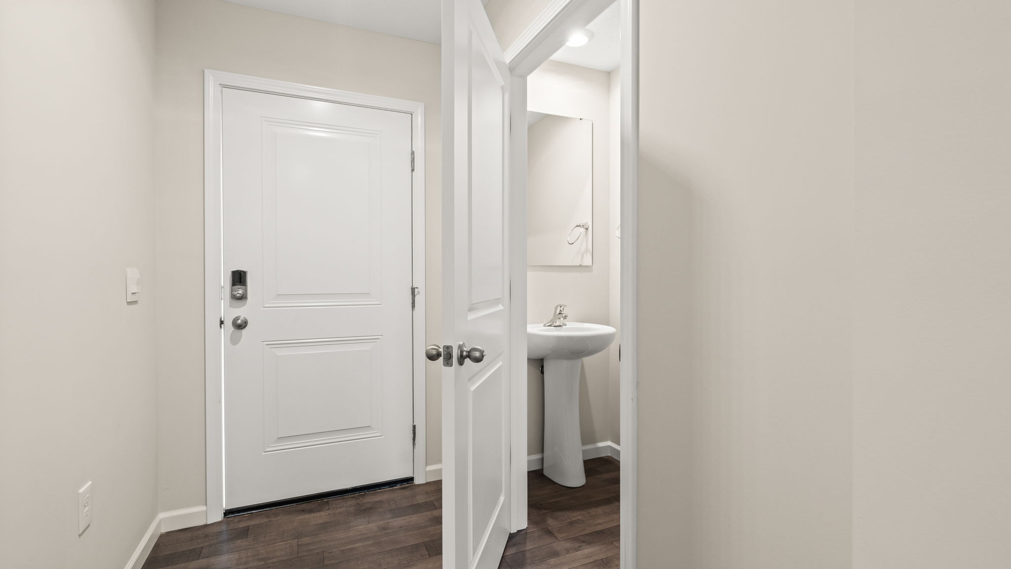 Front of home with front door on the left and powder room on the right.