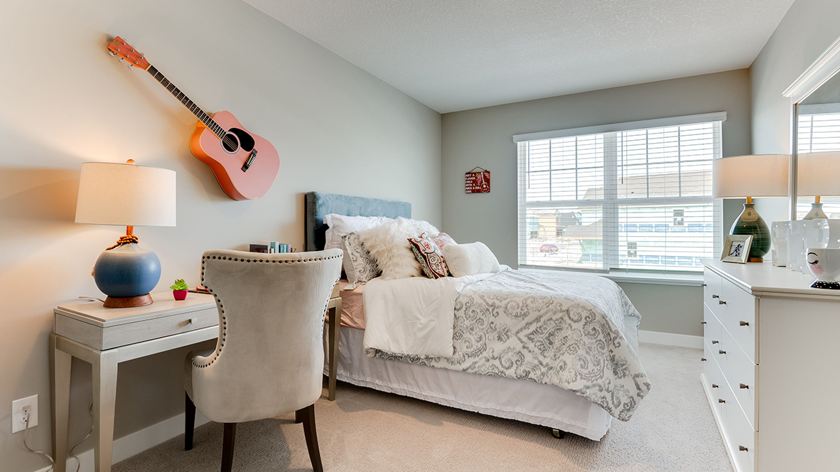 Side view of bedroom with music theme including a guitar on the wall.