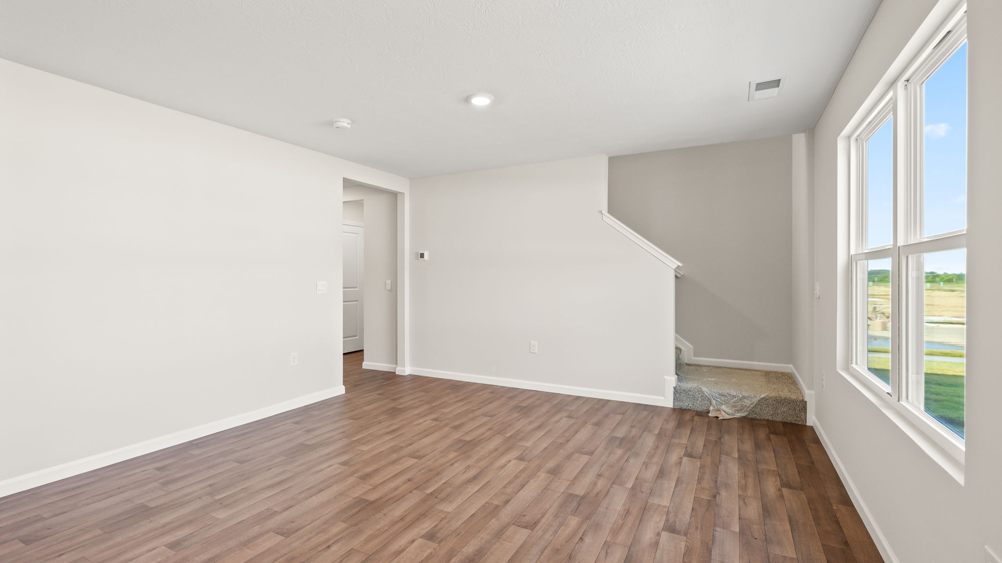 Great room leading to upstairs and foyer