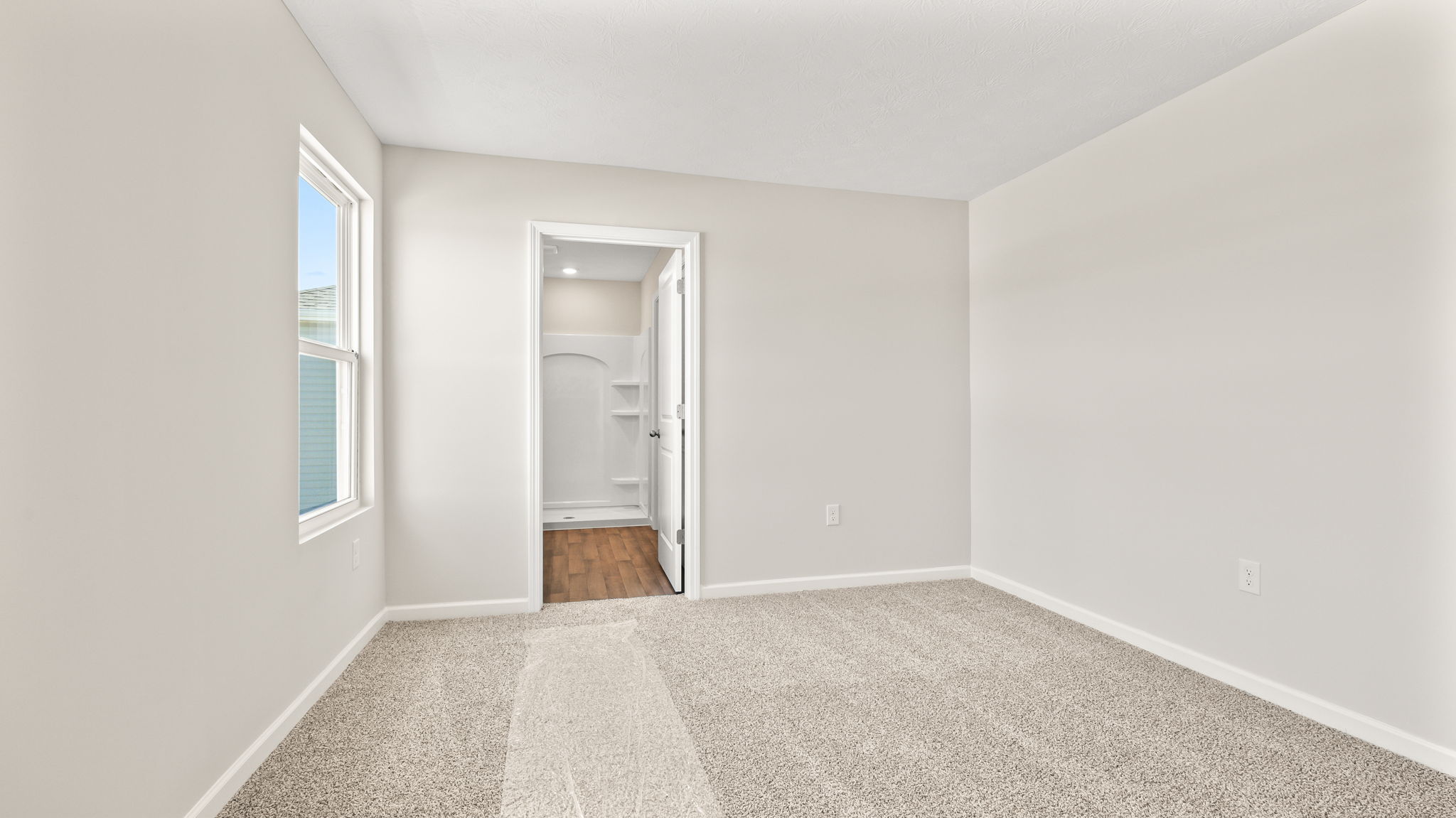 Carpeted primary bedroom