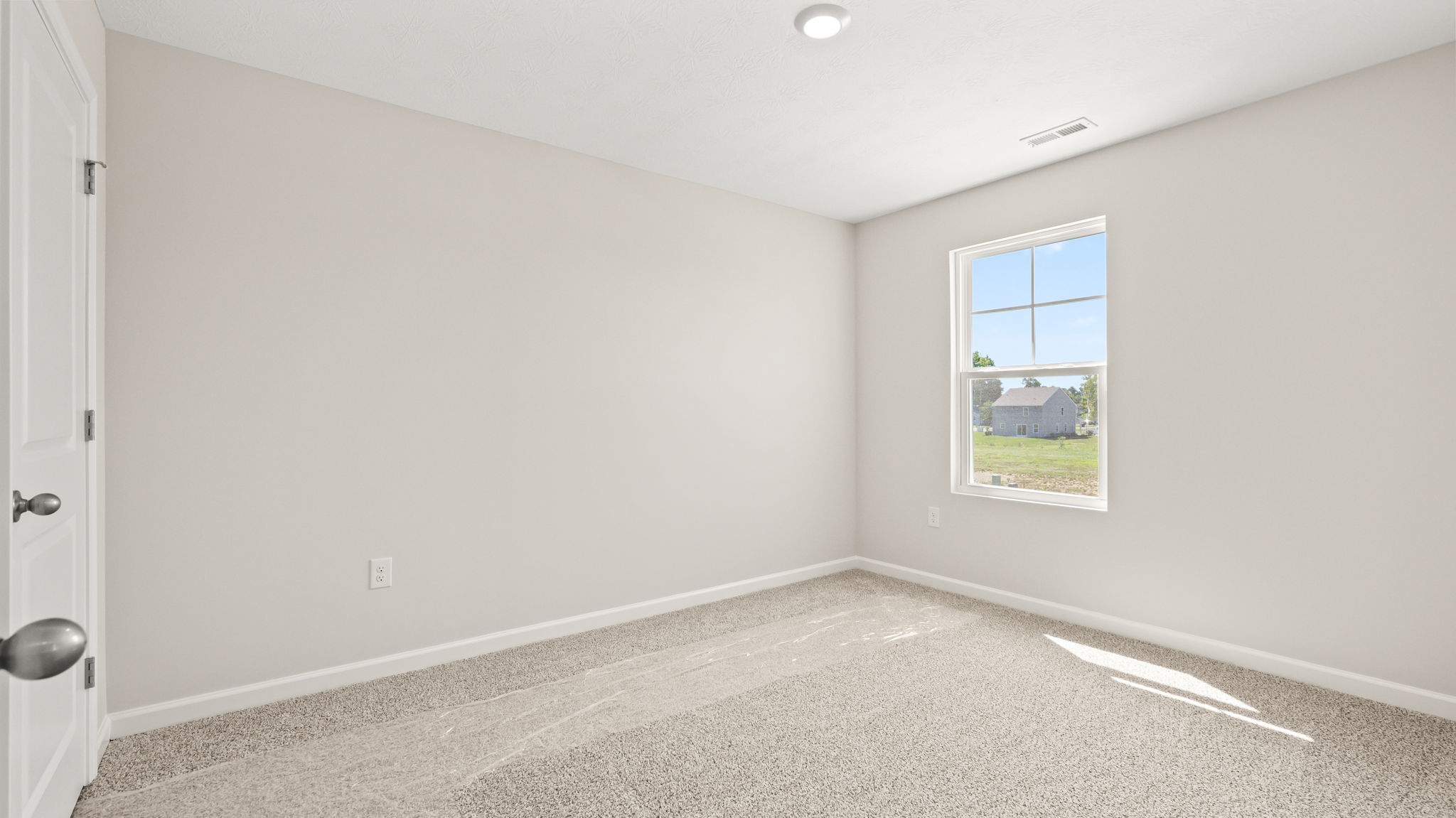Carpeted bedroom with window