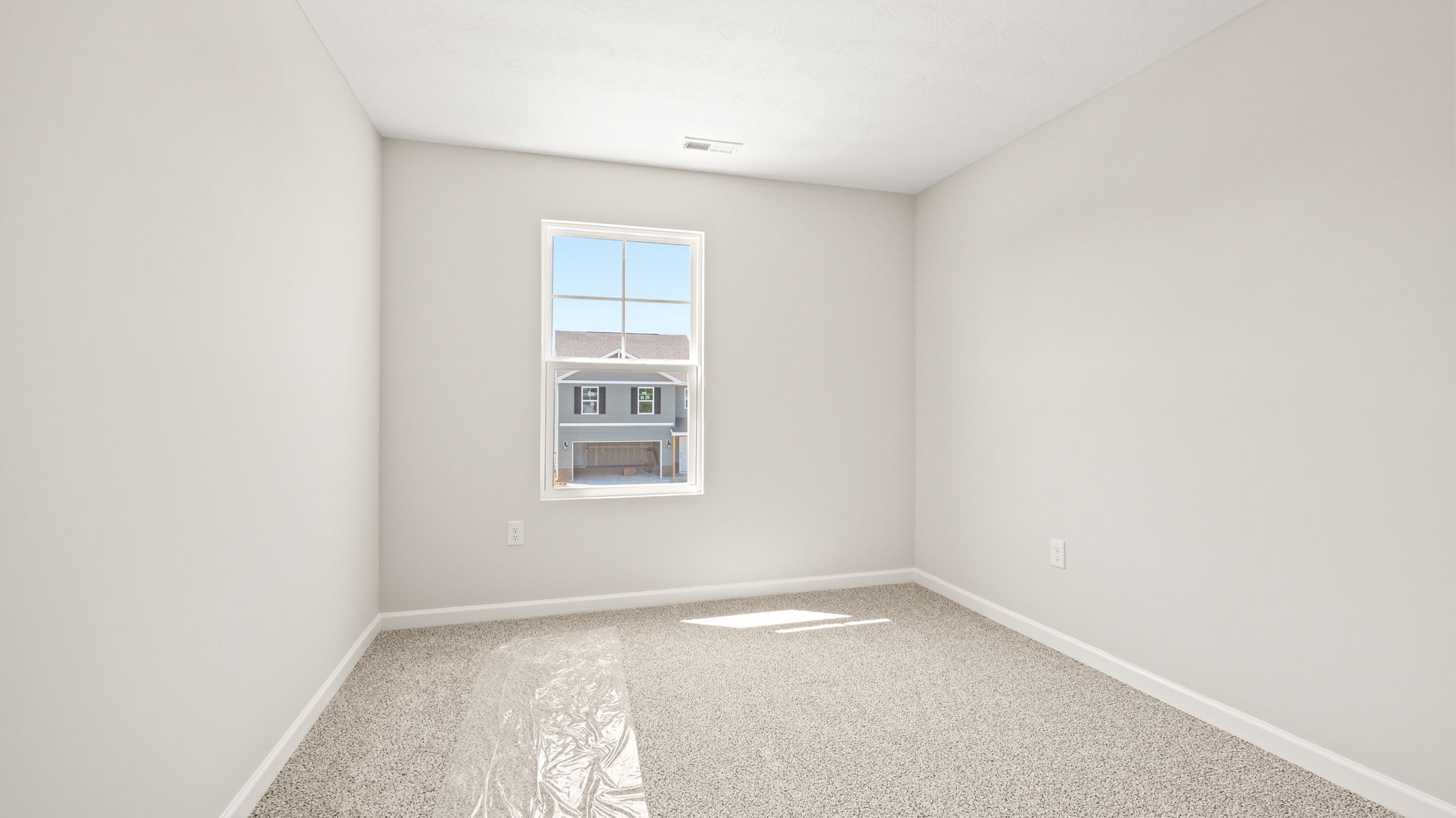 Carpeted bedroom with window