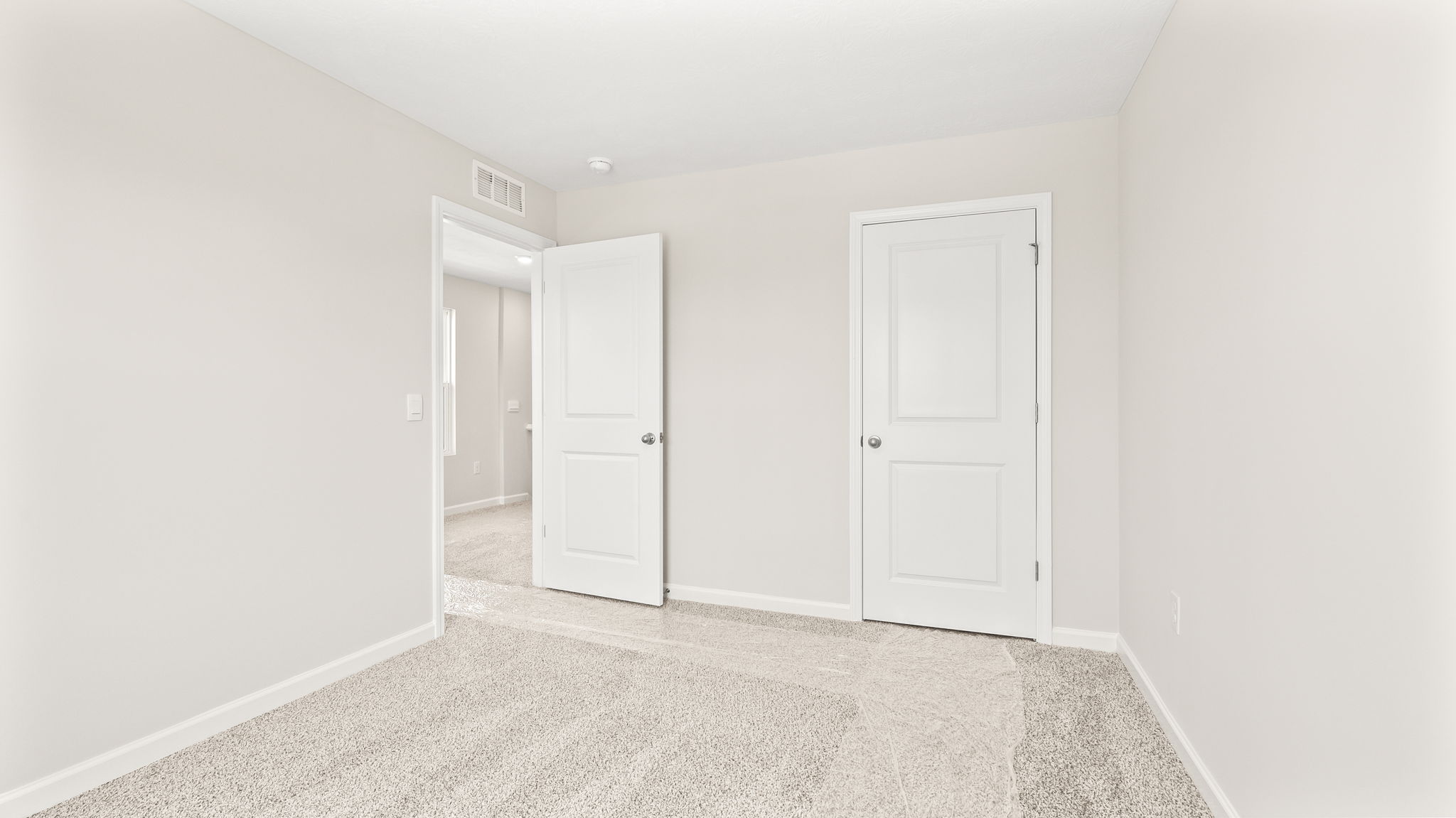 Carpeted bedroom with door