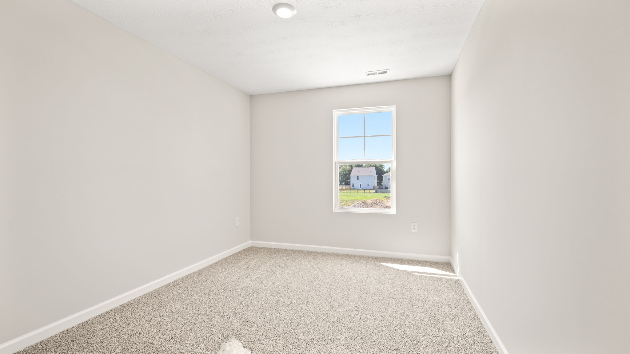 Carpeted bedroom with window