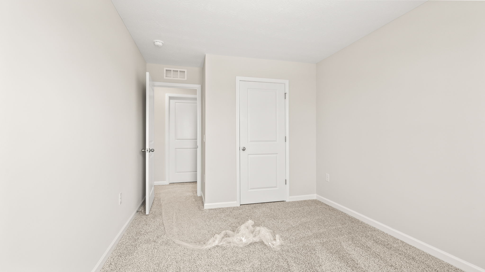 Carpeted bedroom with closet