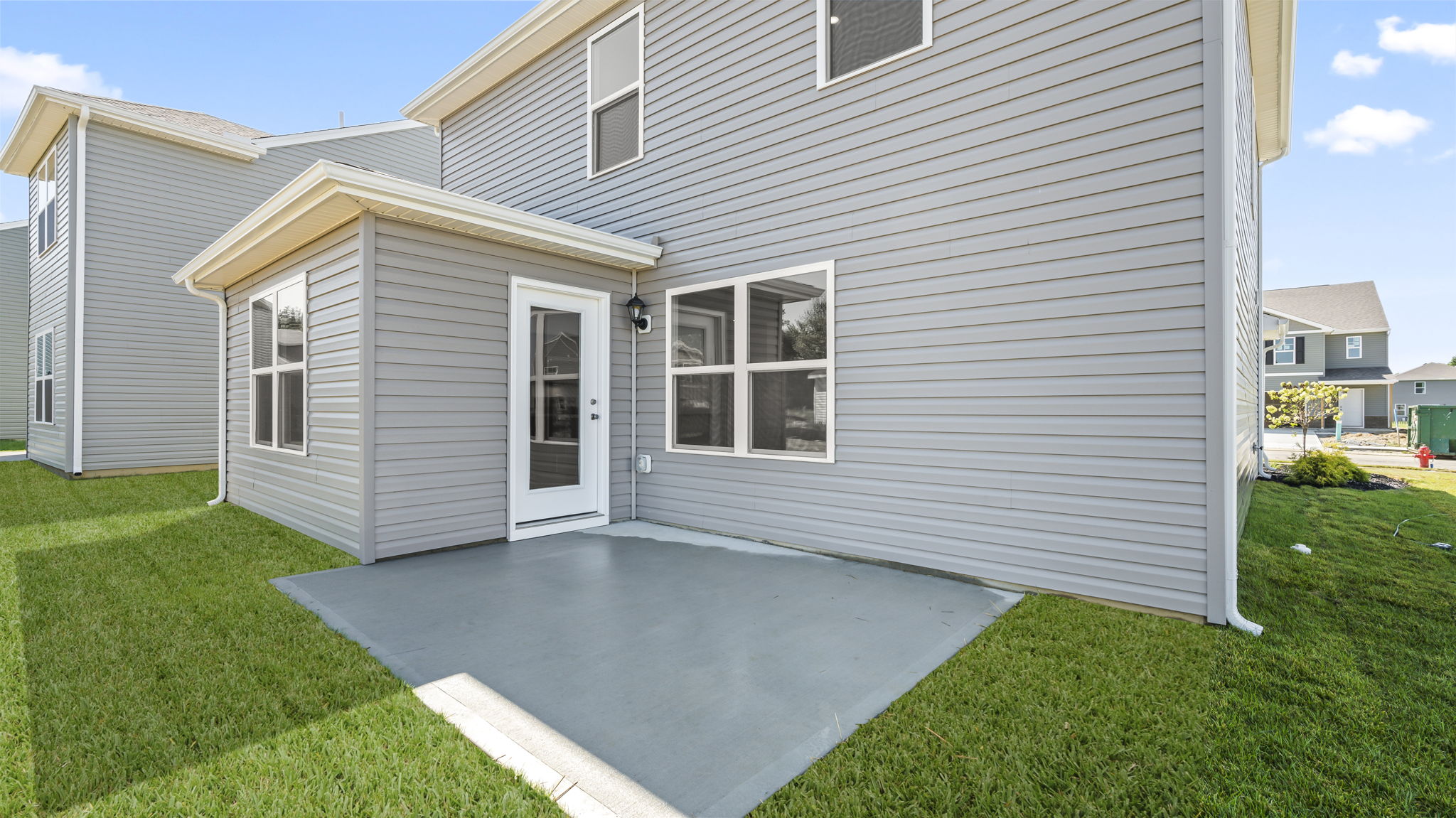 Rear of home with concrete patio