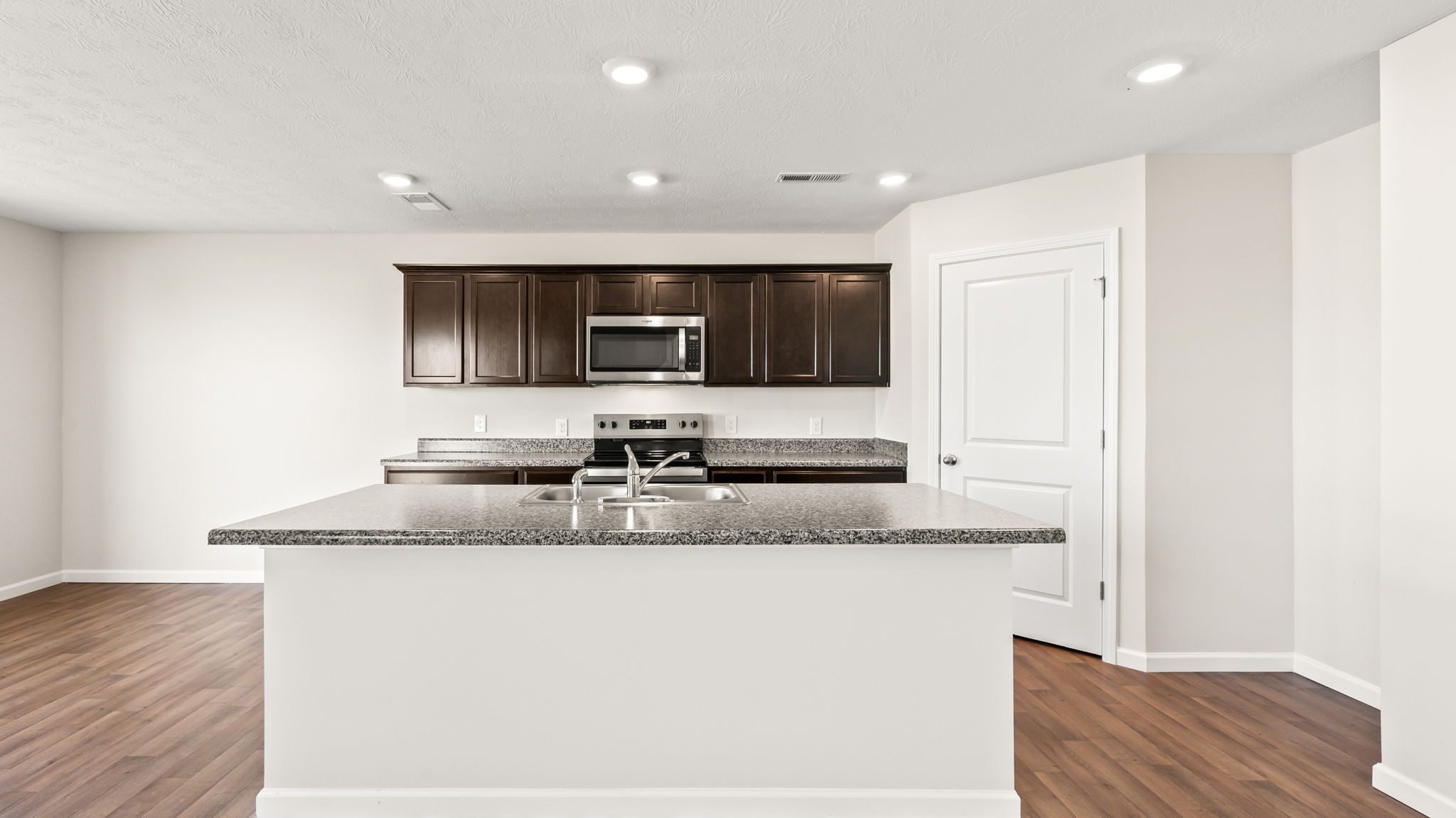 Direct image of kitchen with island with sarsaparilla cabinets