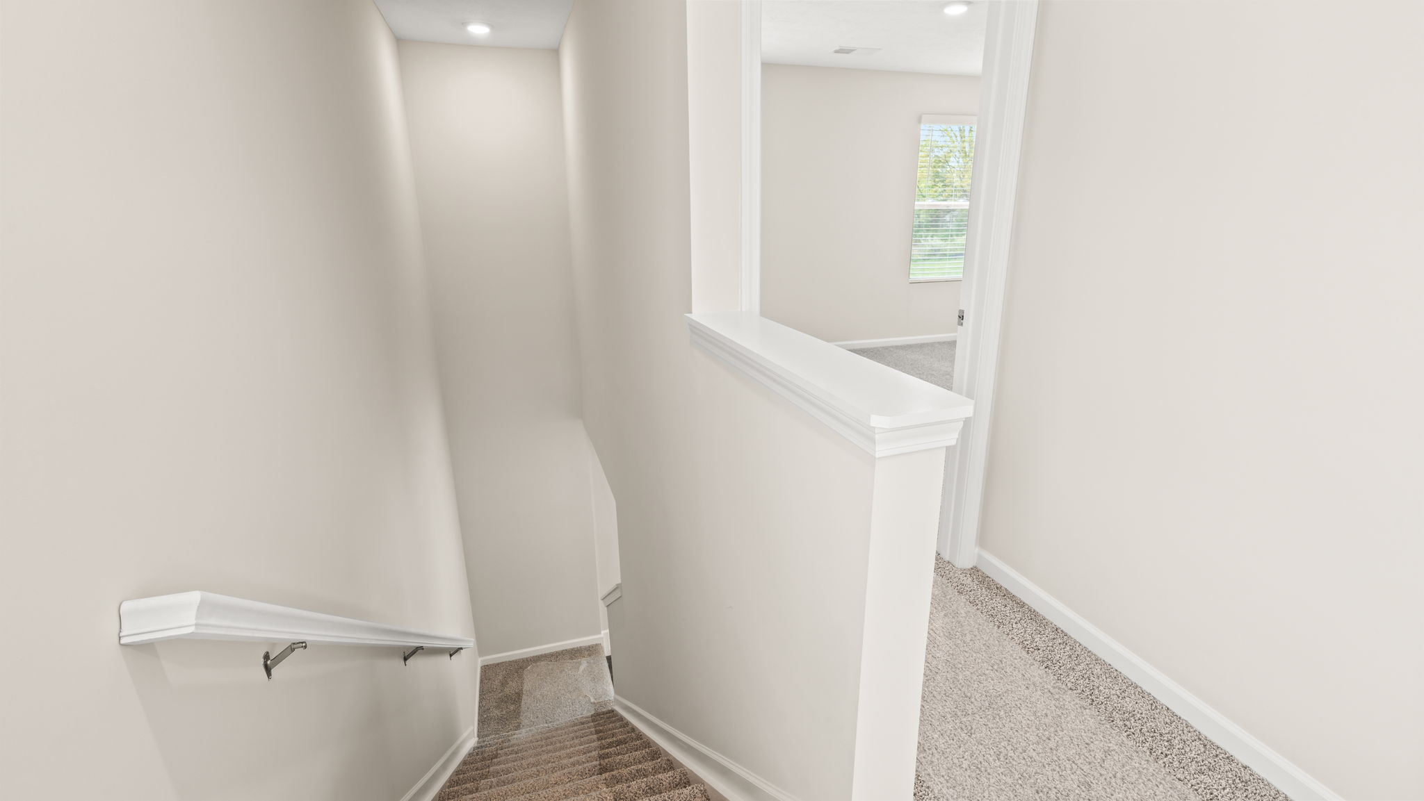 Upstairs landing leading towards downstairs on the left and bedrooms on the right