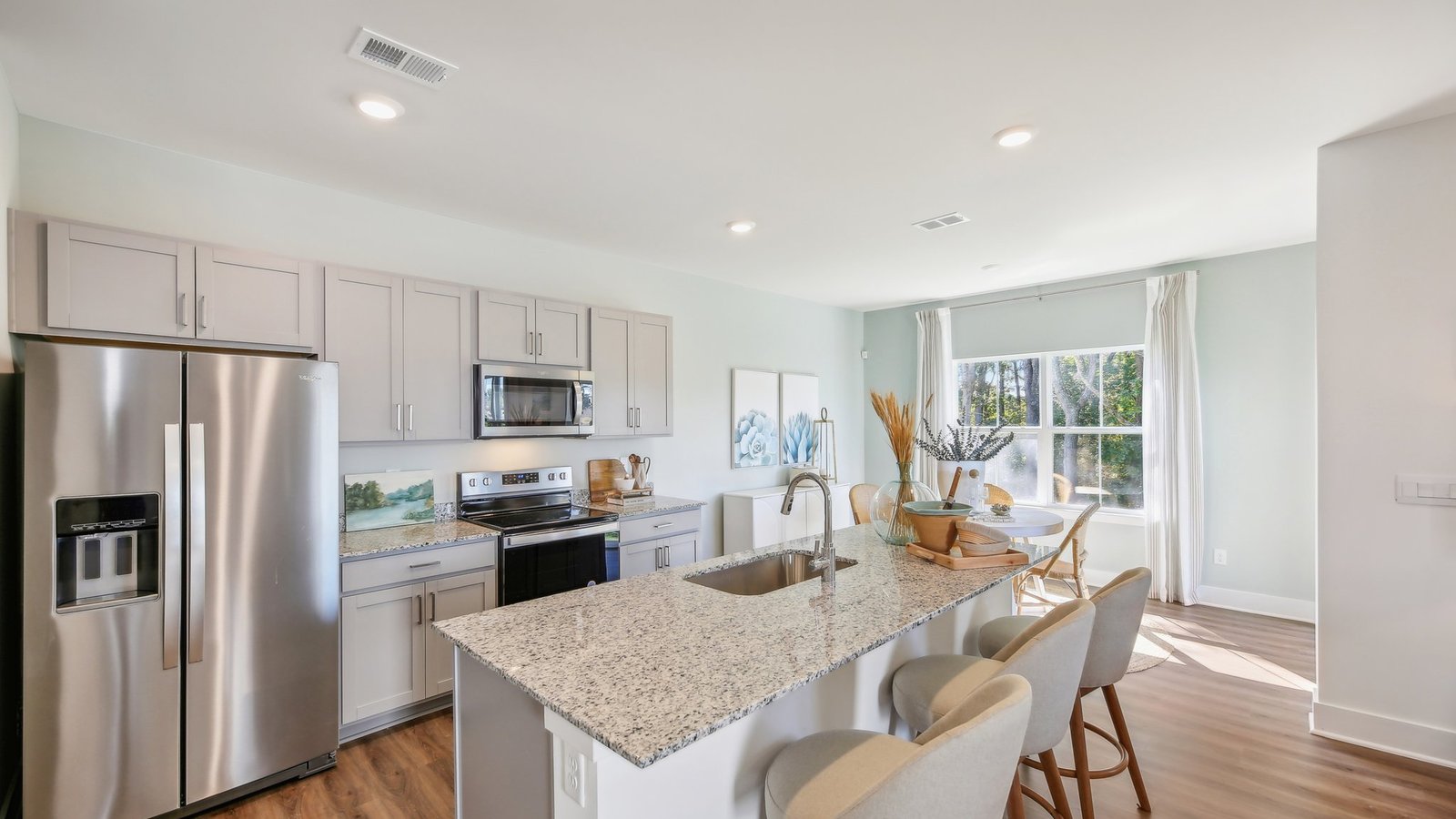 Kitchen with grey cabinets and stainless steel appliances.