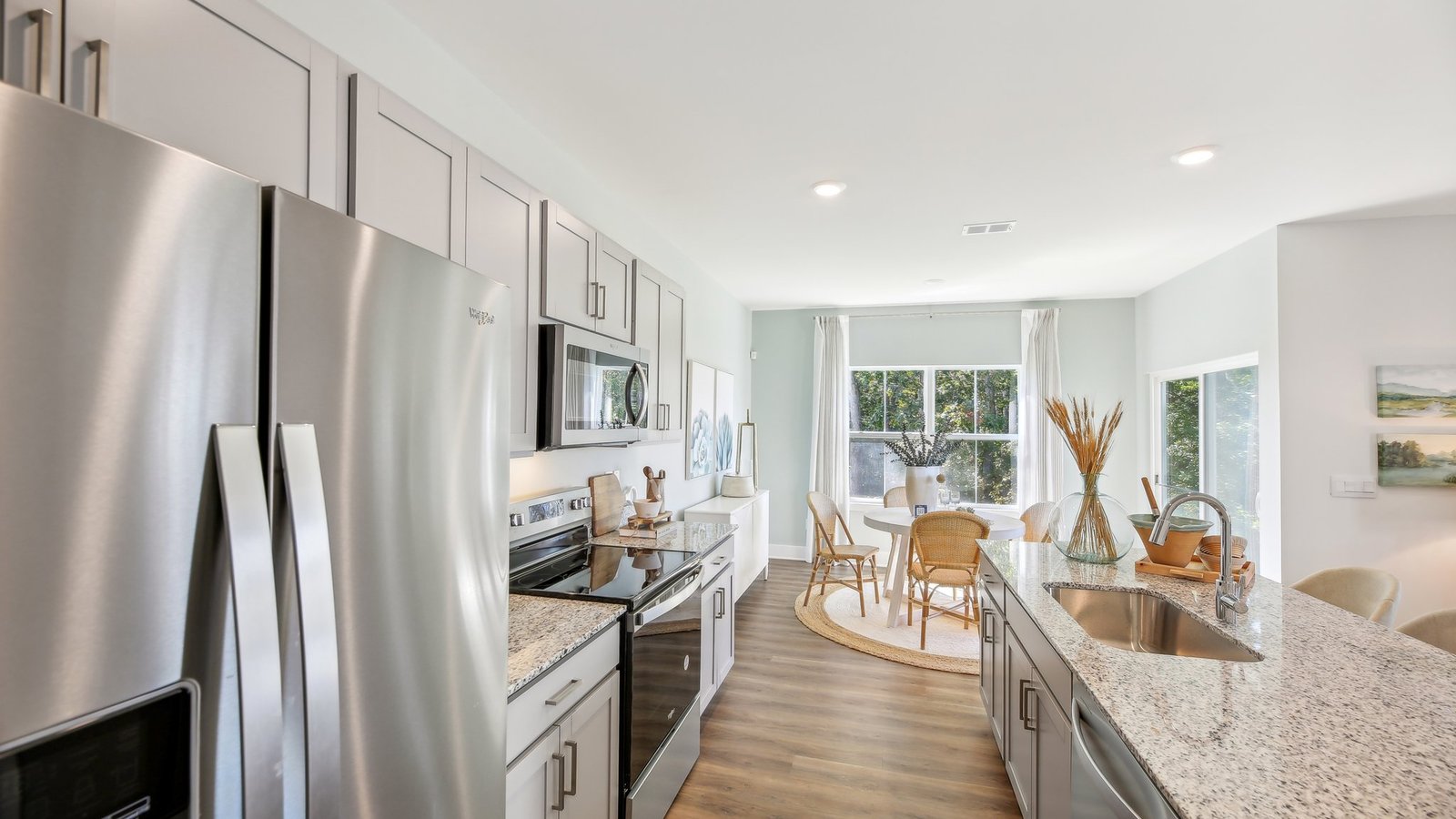 Kitchen with grey cabinets and stainless steel appliances.