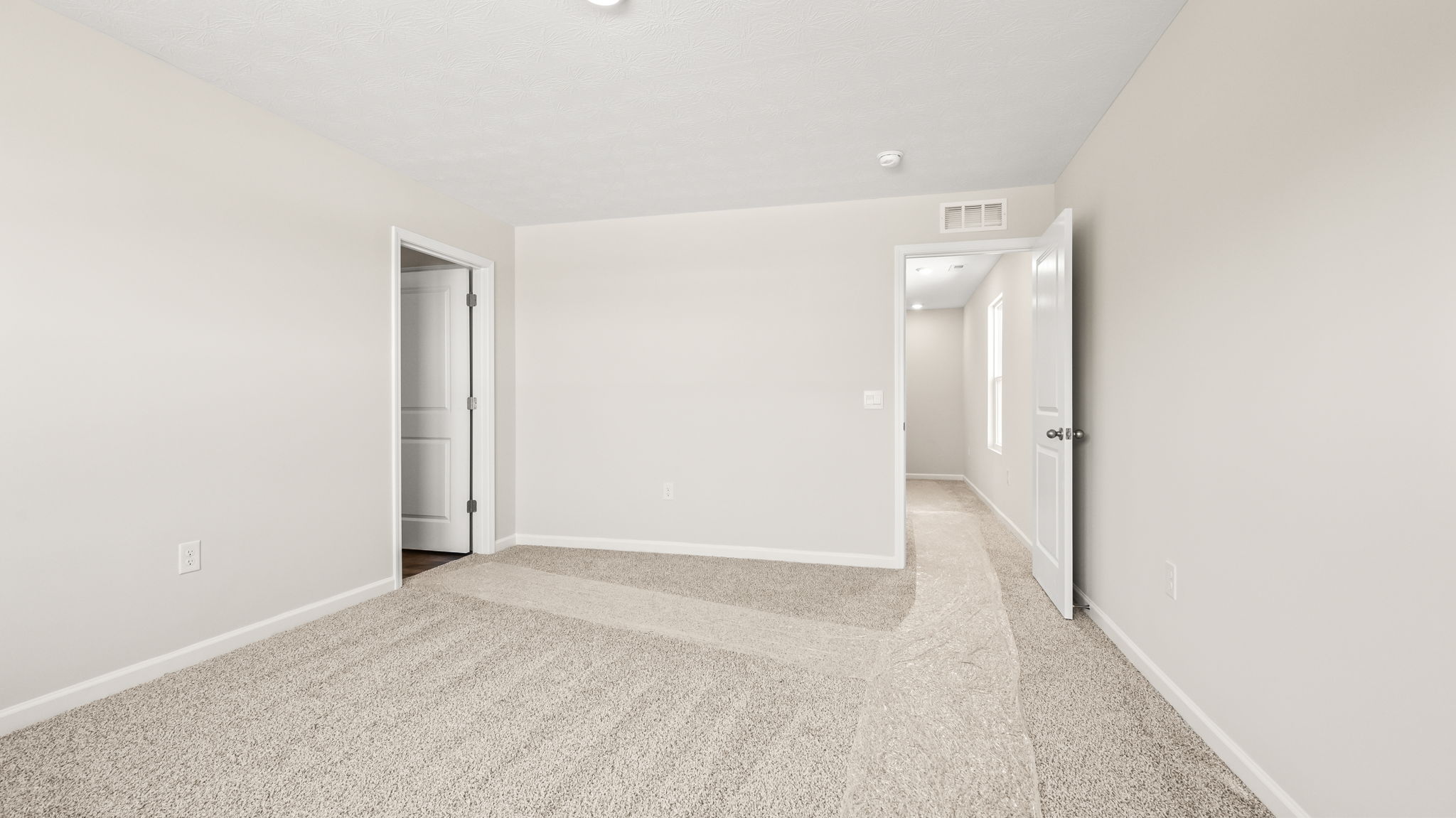 Carpeted primary bedroom