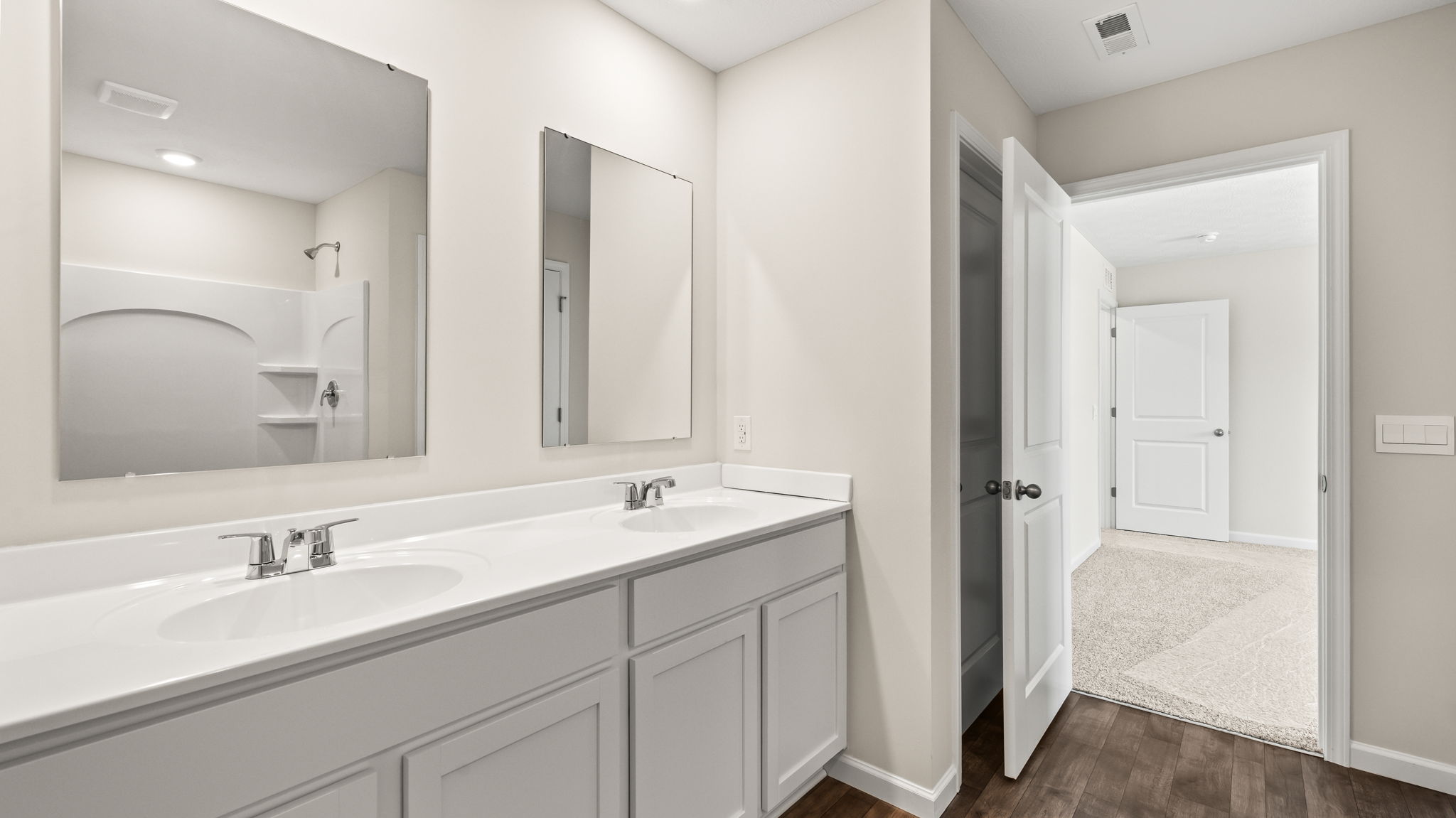 primary bathroom with dual vanity sinks