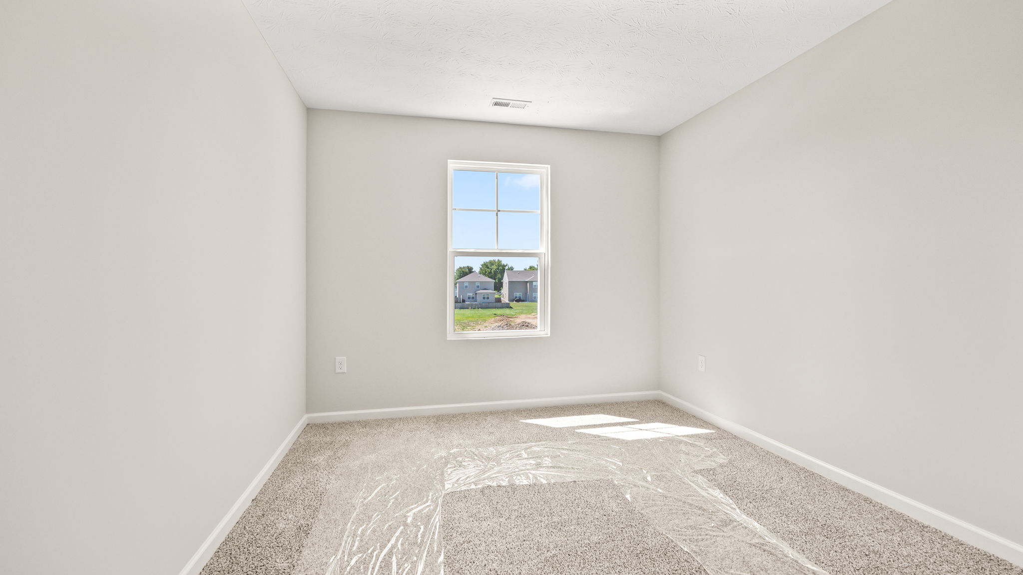 Carpeted bedroom with window