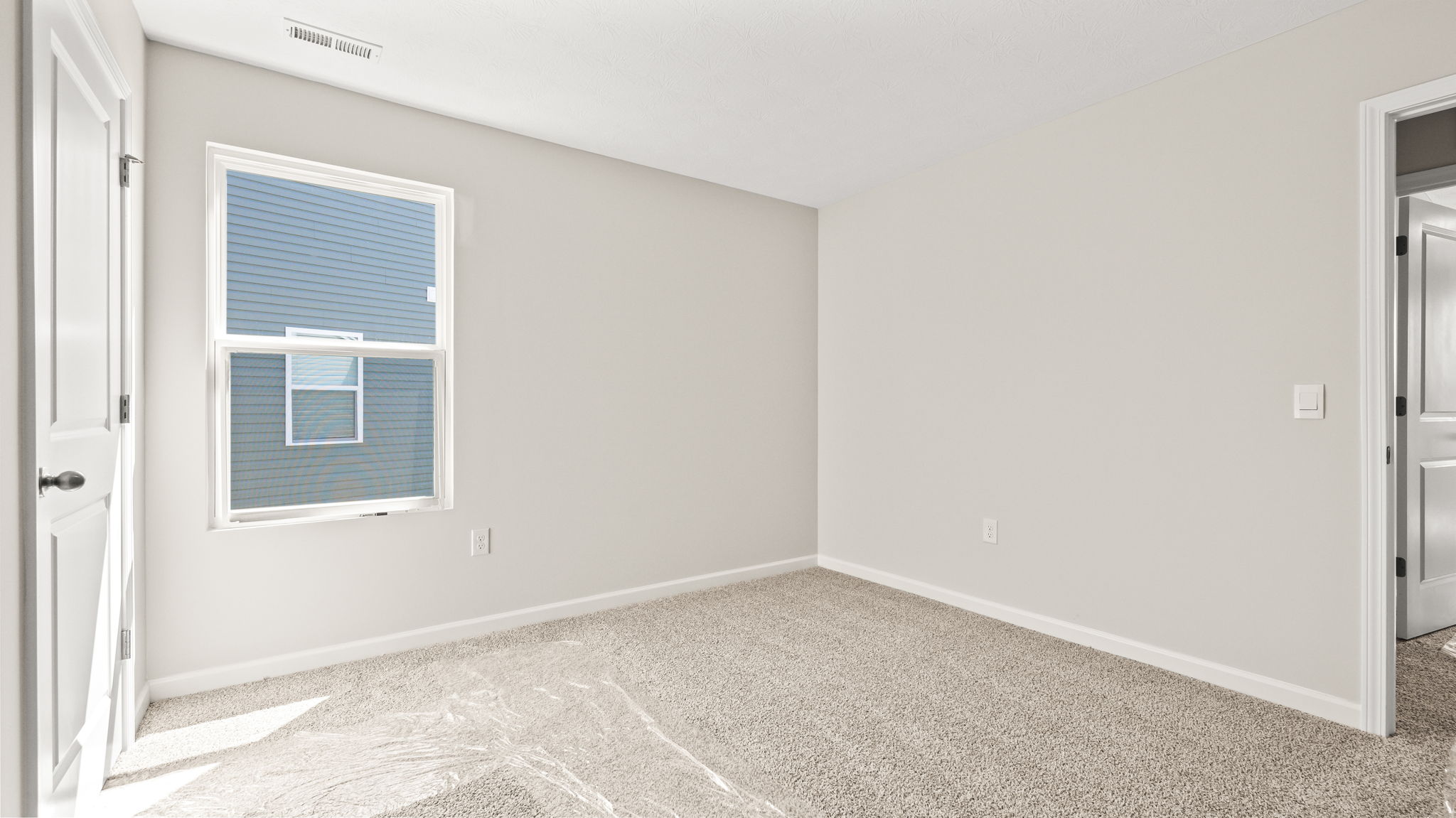 Carpeted bedroom with window