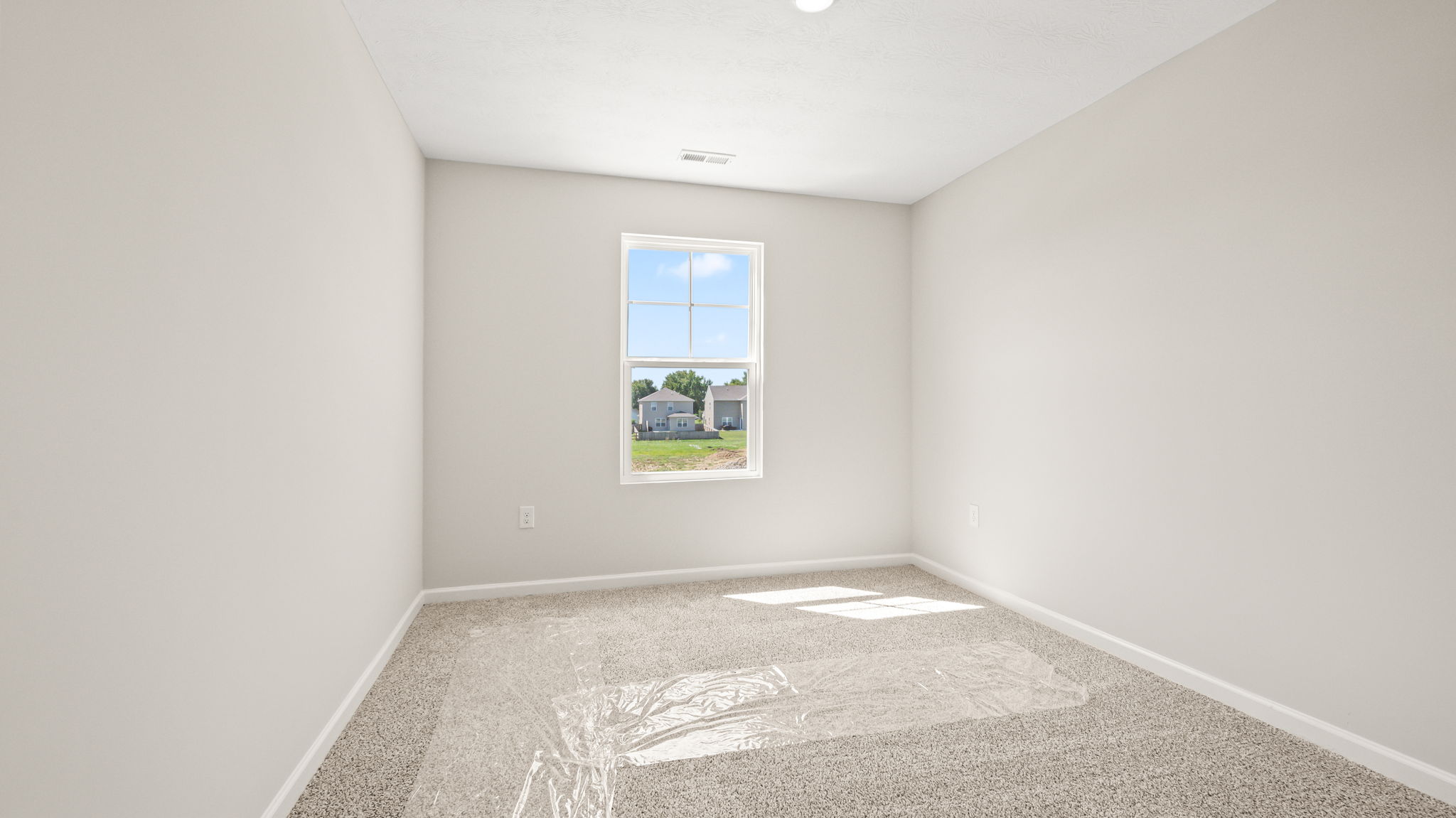 Carpeted bedroom with window