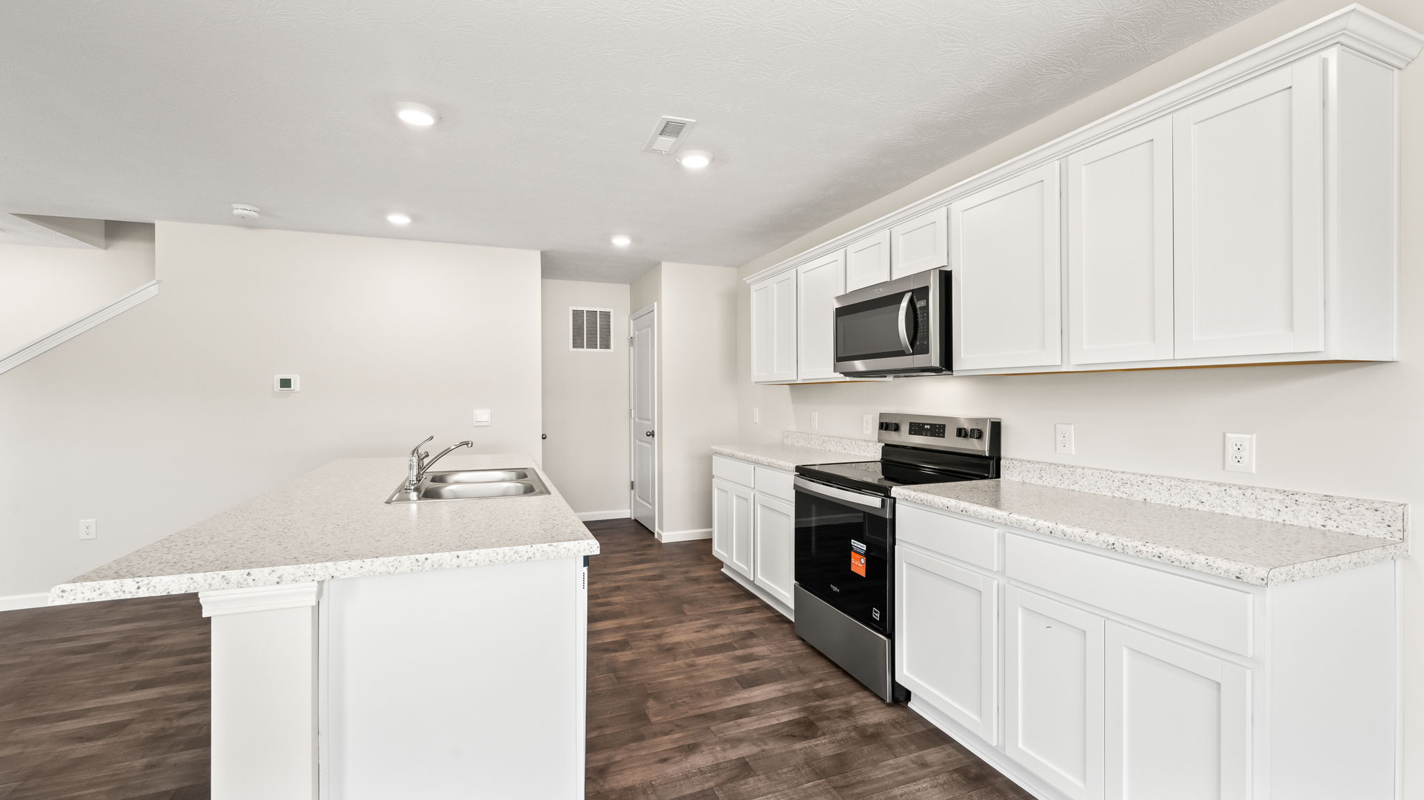 Side view of kitchen with white cabinetry