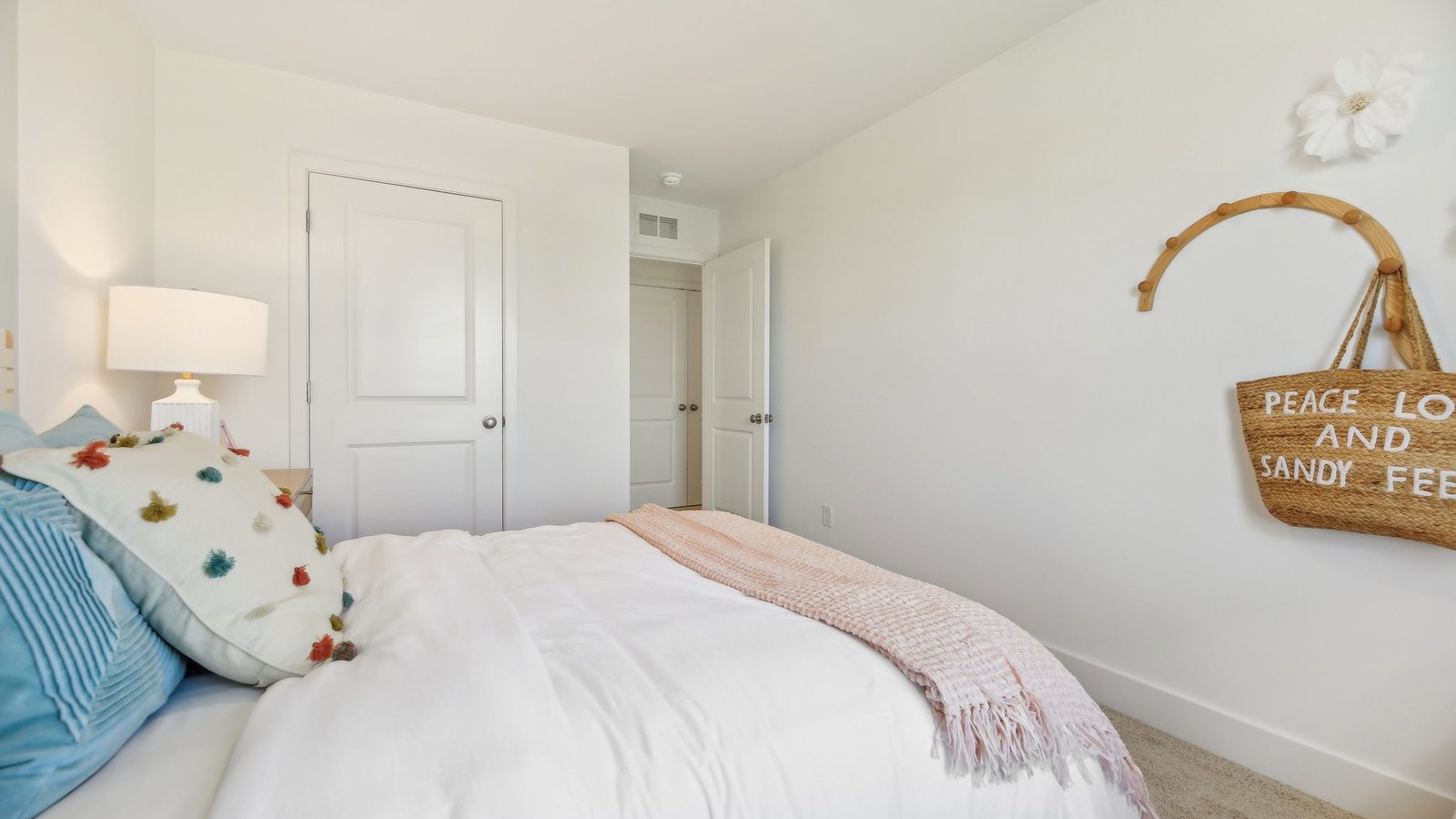 Bedroom with beautiful decorations and view into hallway.