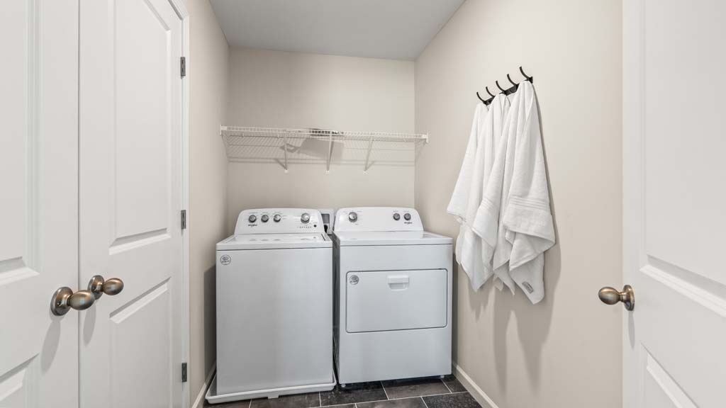 Laundry room with whirlpool washer and dryers.