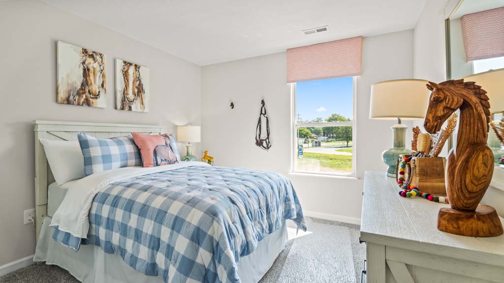 Bedroom with horse theme featuring large bed and wooden accents.