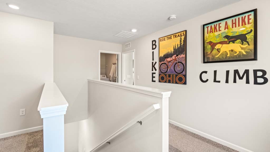 Upstairs landing with biking and climbing posters.