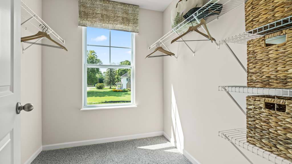 walkin closet with ample shelf space and hangers.