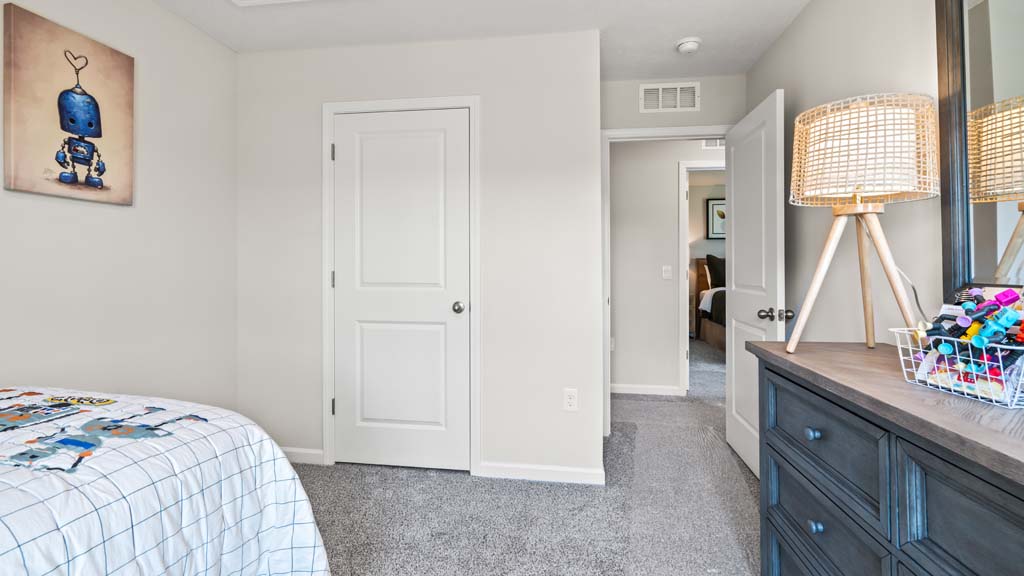 bedroom with robot theme for young child and door to the hallway.