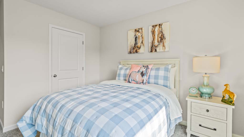 Bedroom with horse theme featuring large bed and wooden accents.